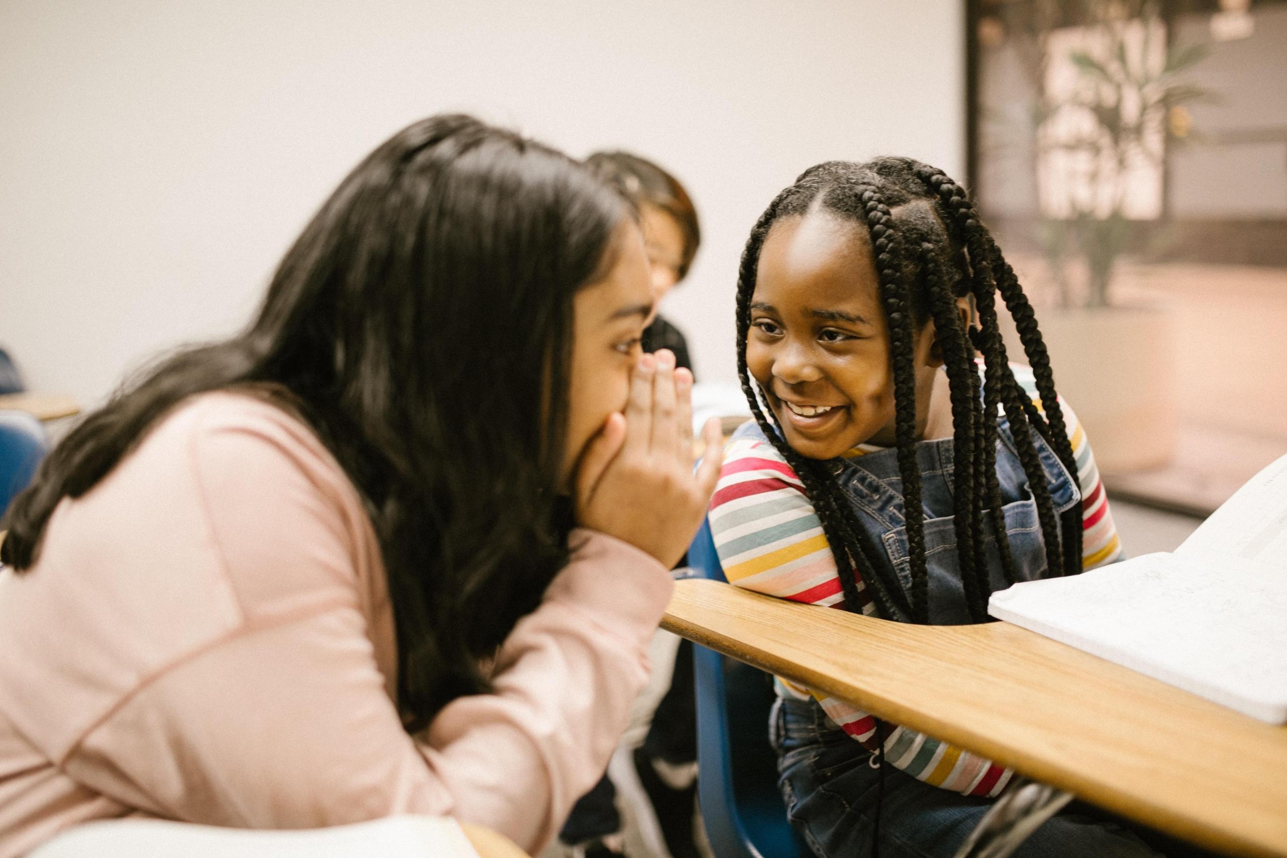 two girls chatting in the classroom
