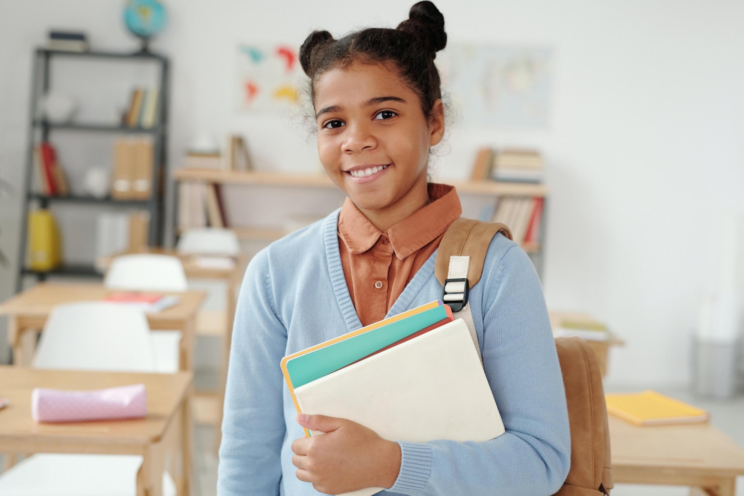 girl leaving class carrying books