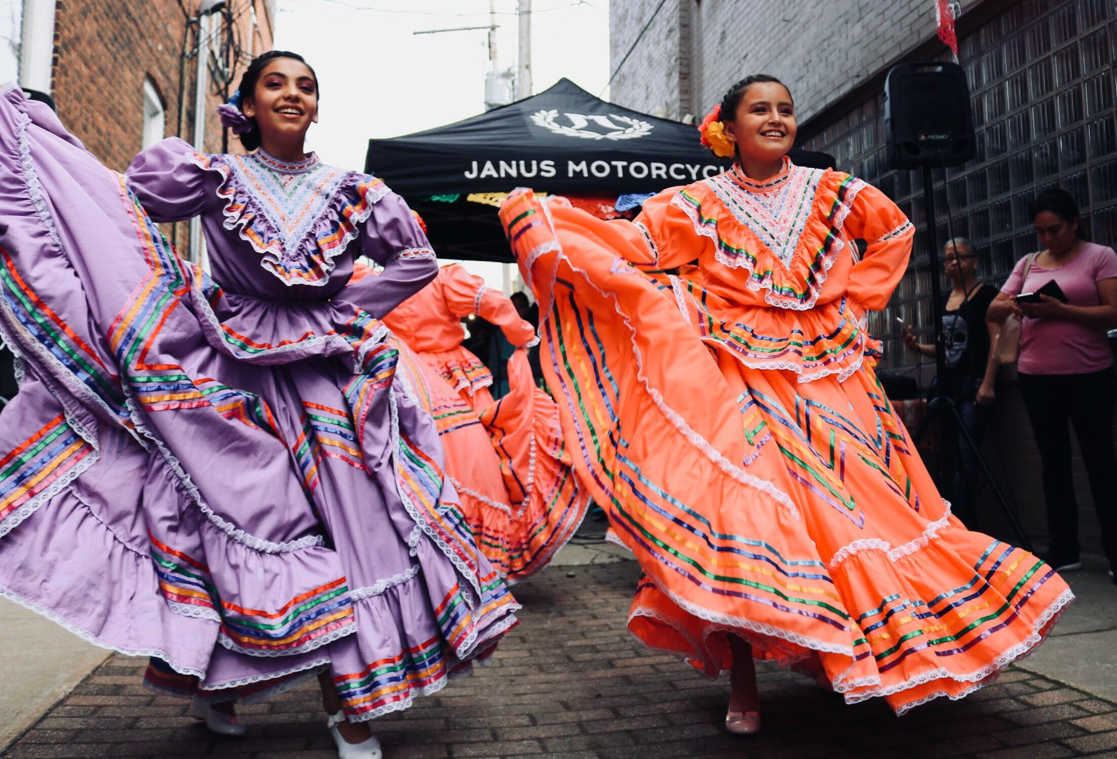 two dancers in colourful spanish costumes