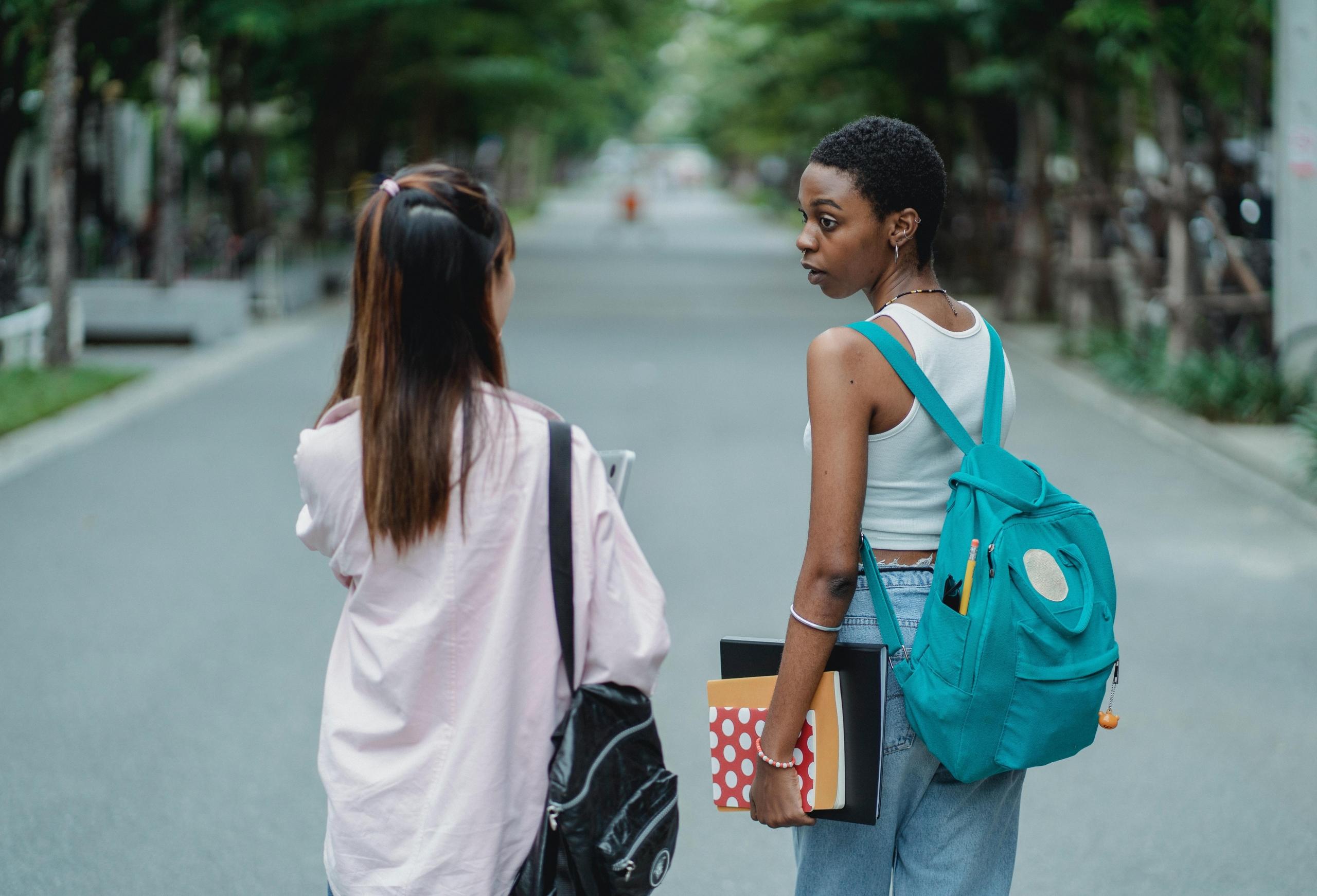 two students walking down the street