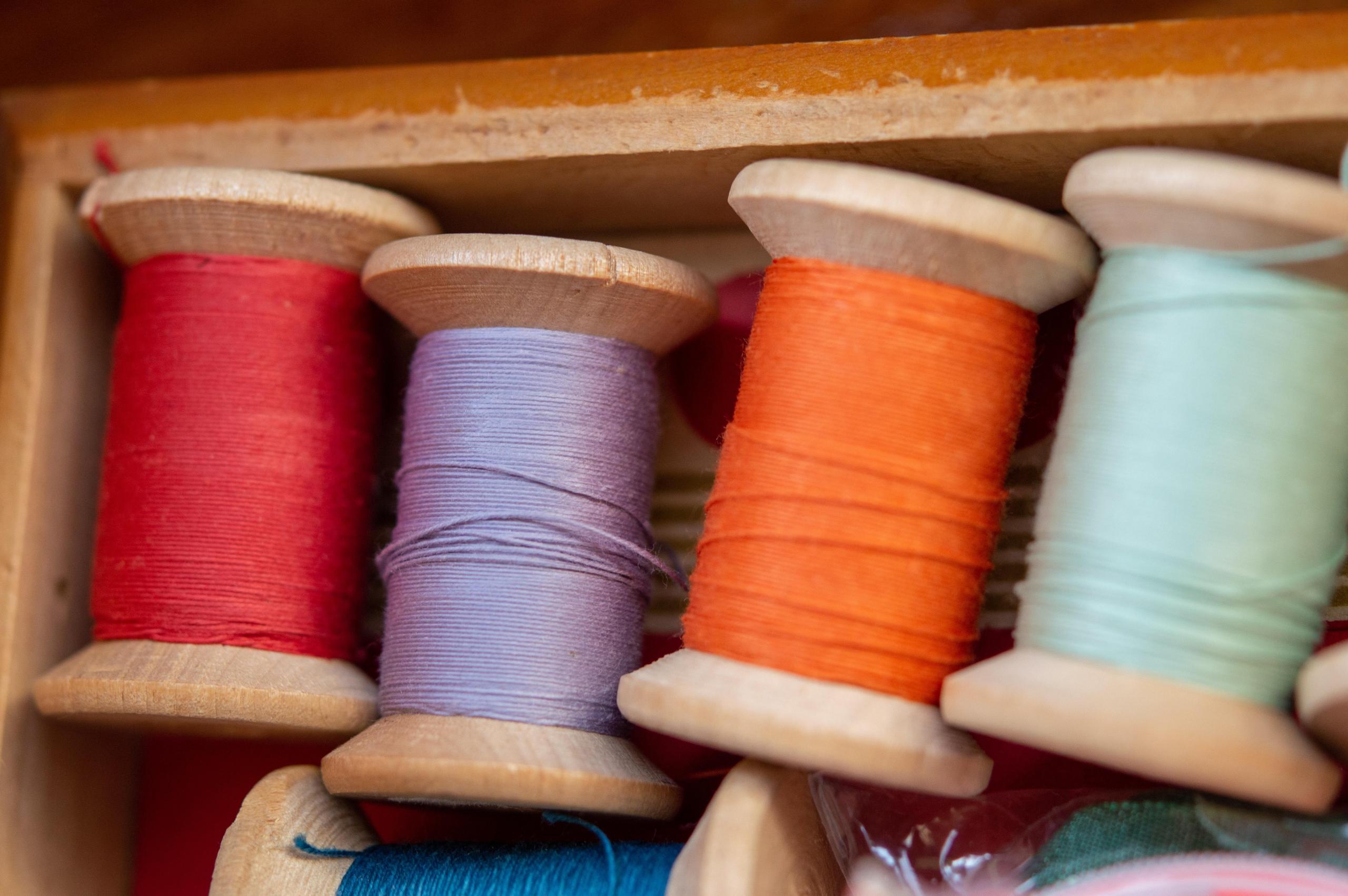 colourful sewing thread on bobbins
