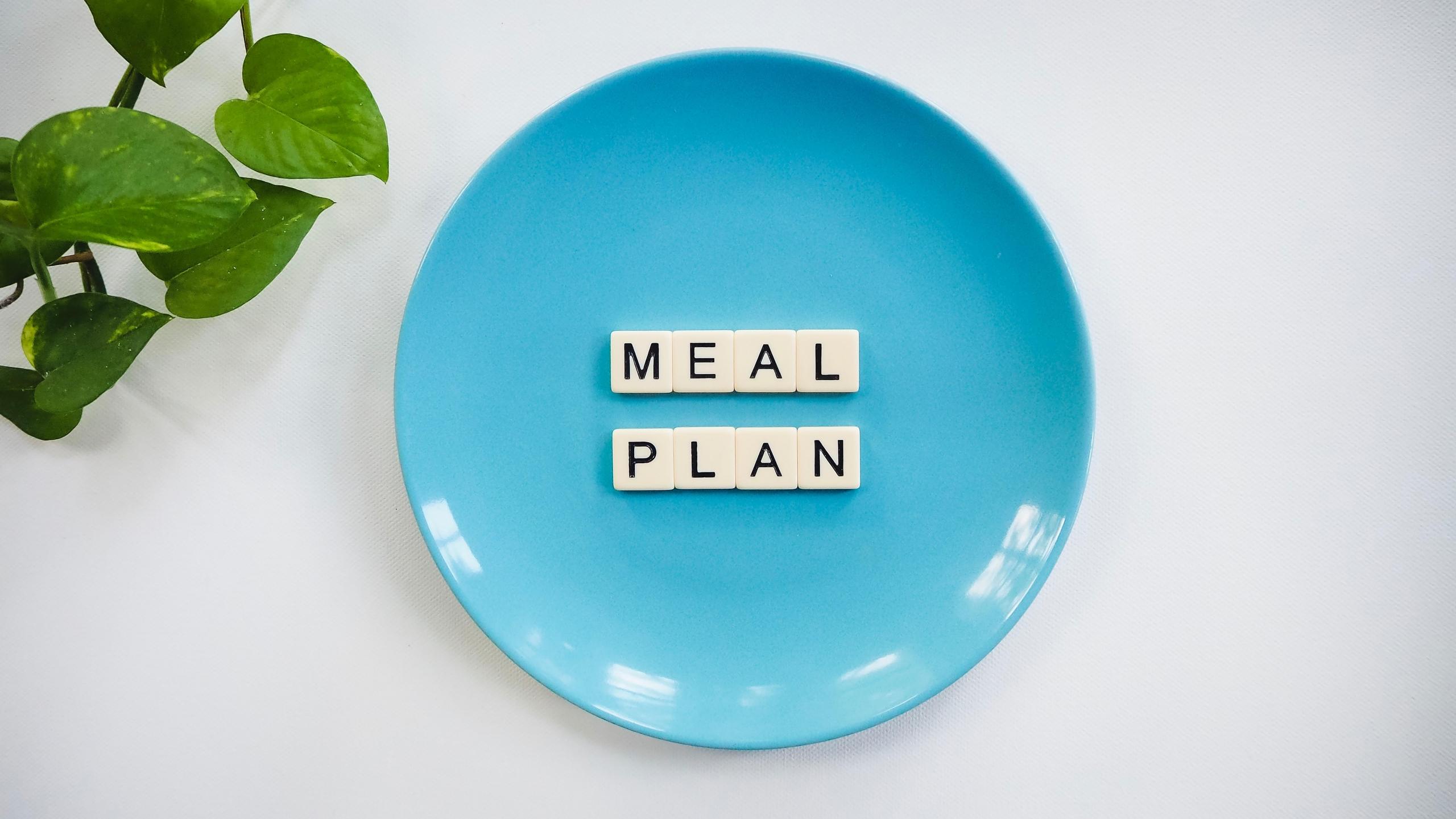 meal plan written with scrabble tiles on blue dinner plate