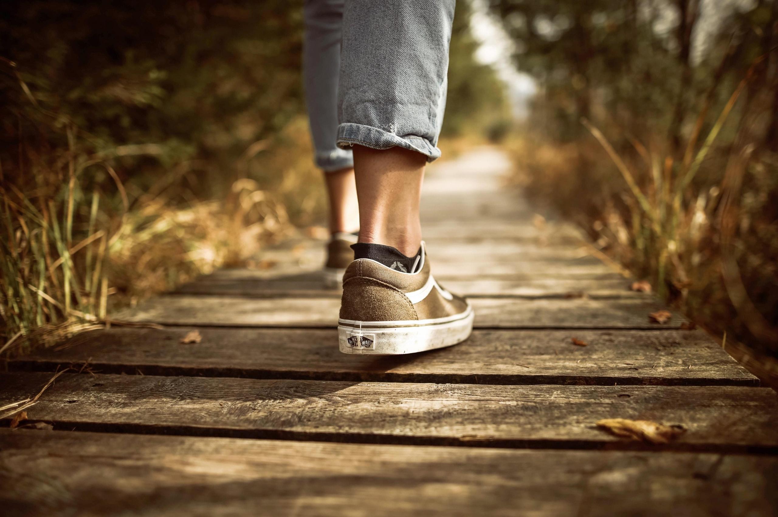 close up of shoes on wooden pathway