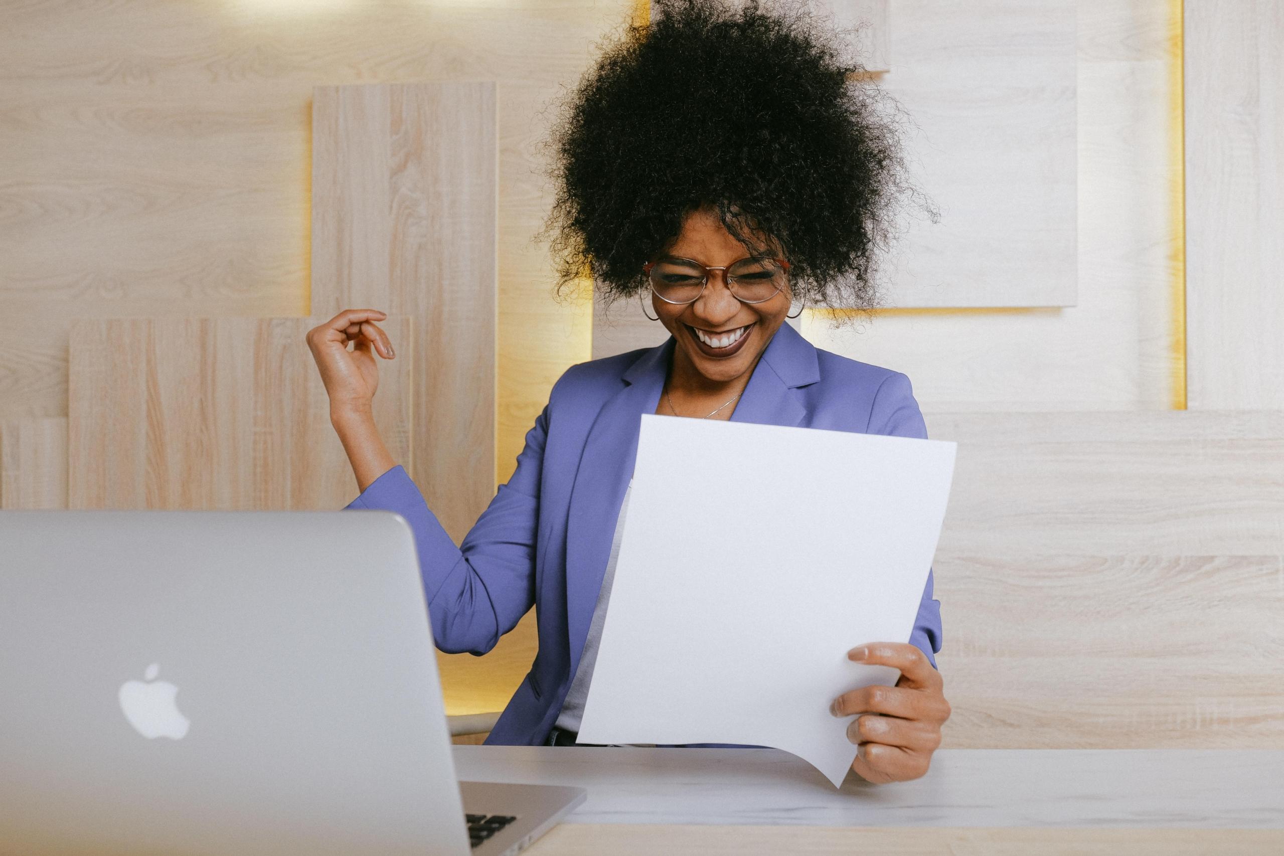 woman reading document and smiling