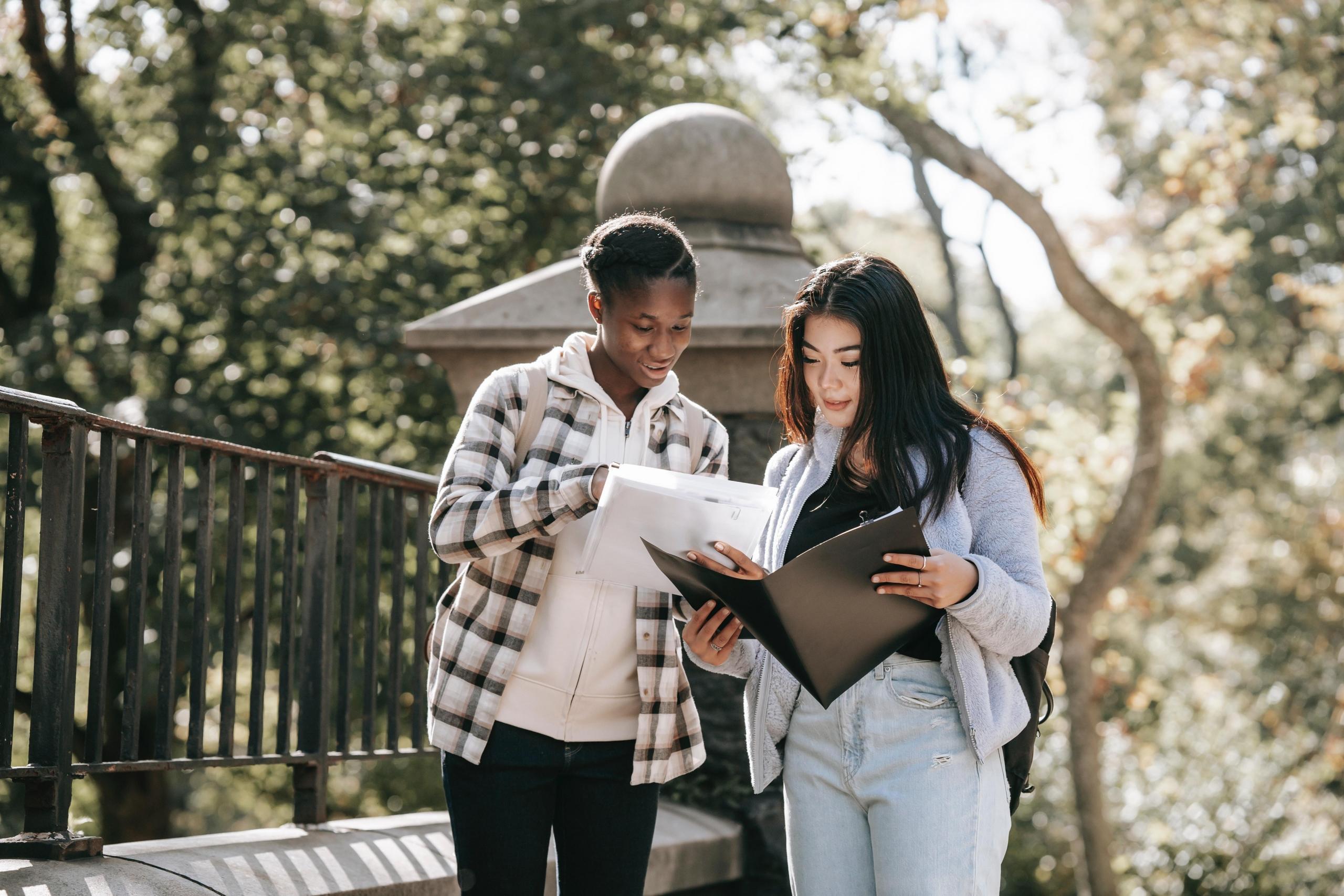 two young women reviewing documents