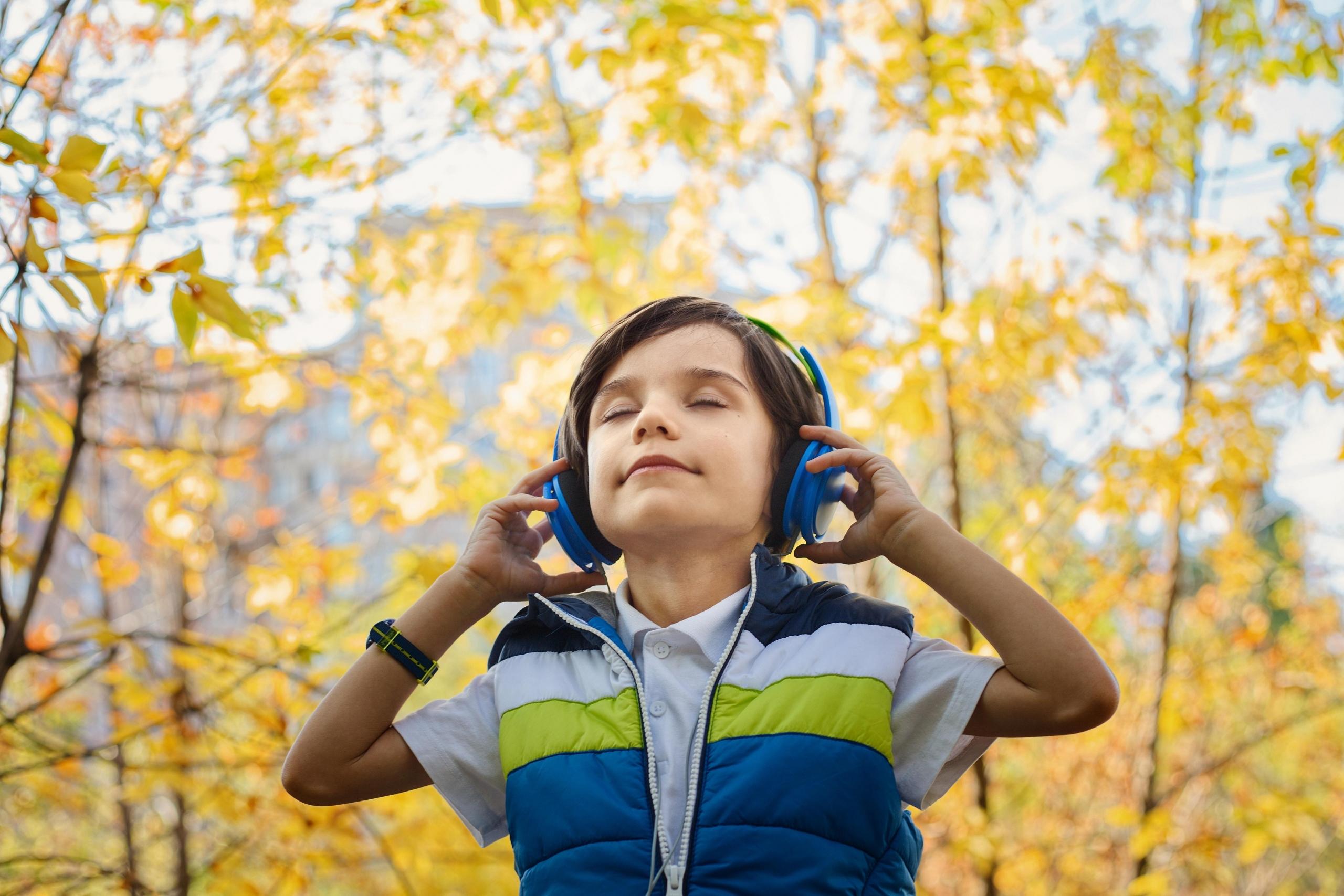boy listening to music outdoors