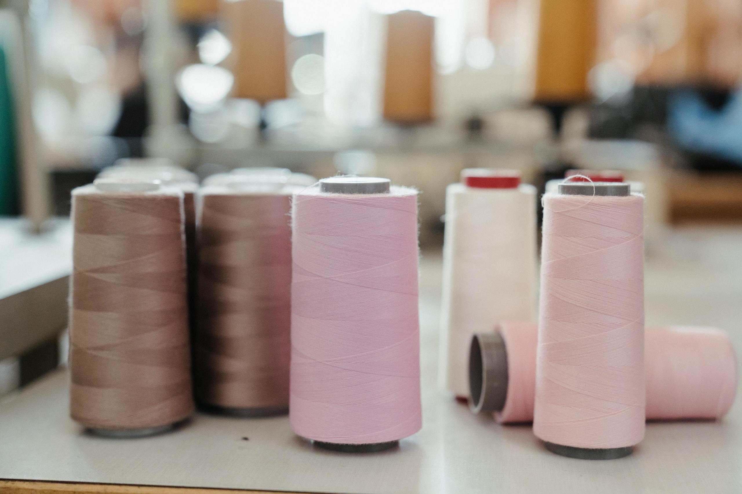 bobbins of pastel coloured thread