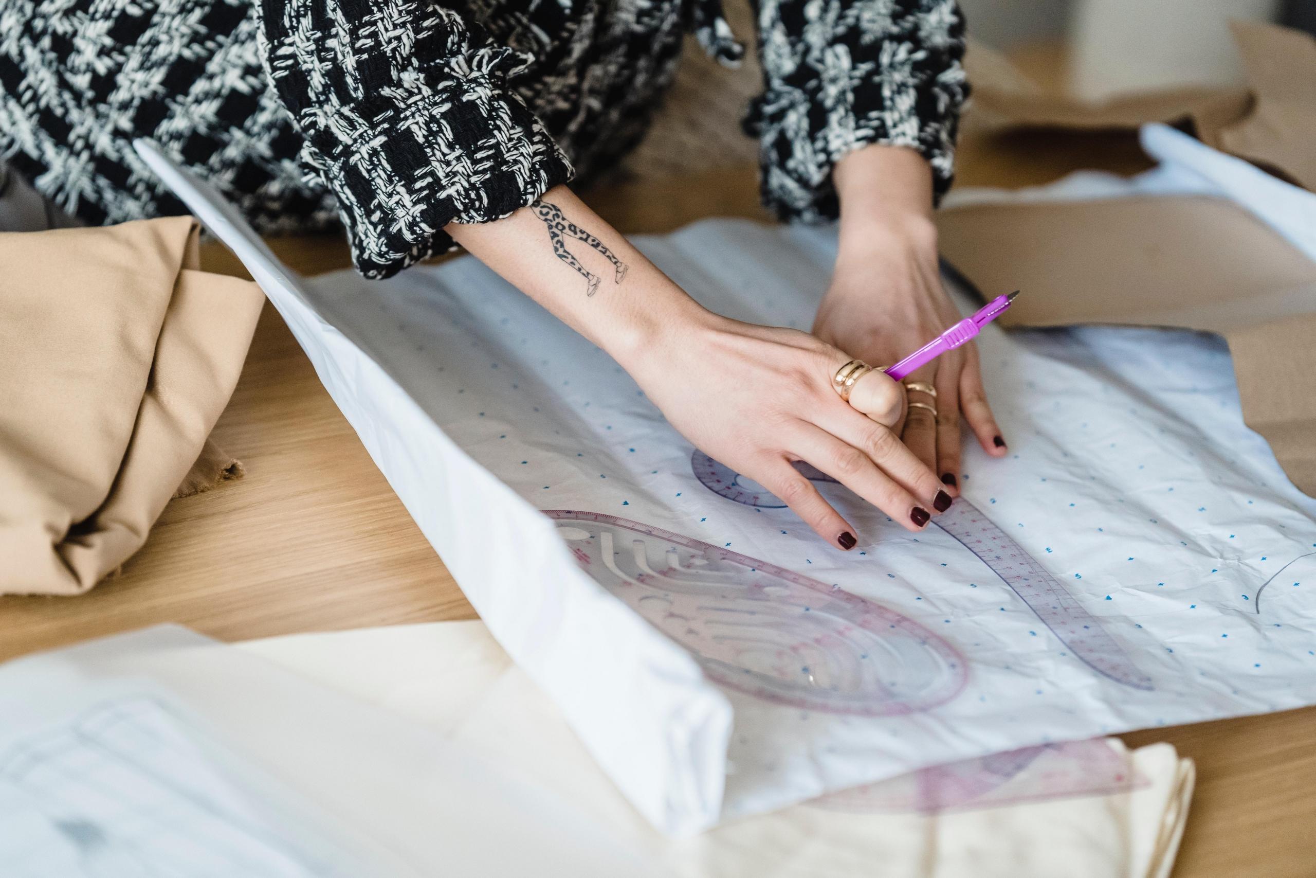 woman transferring sewing pattern onto fabric