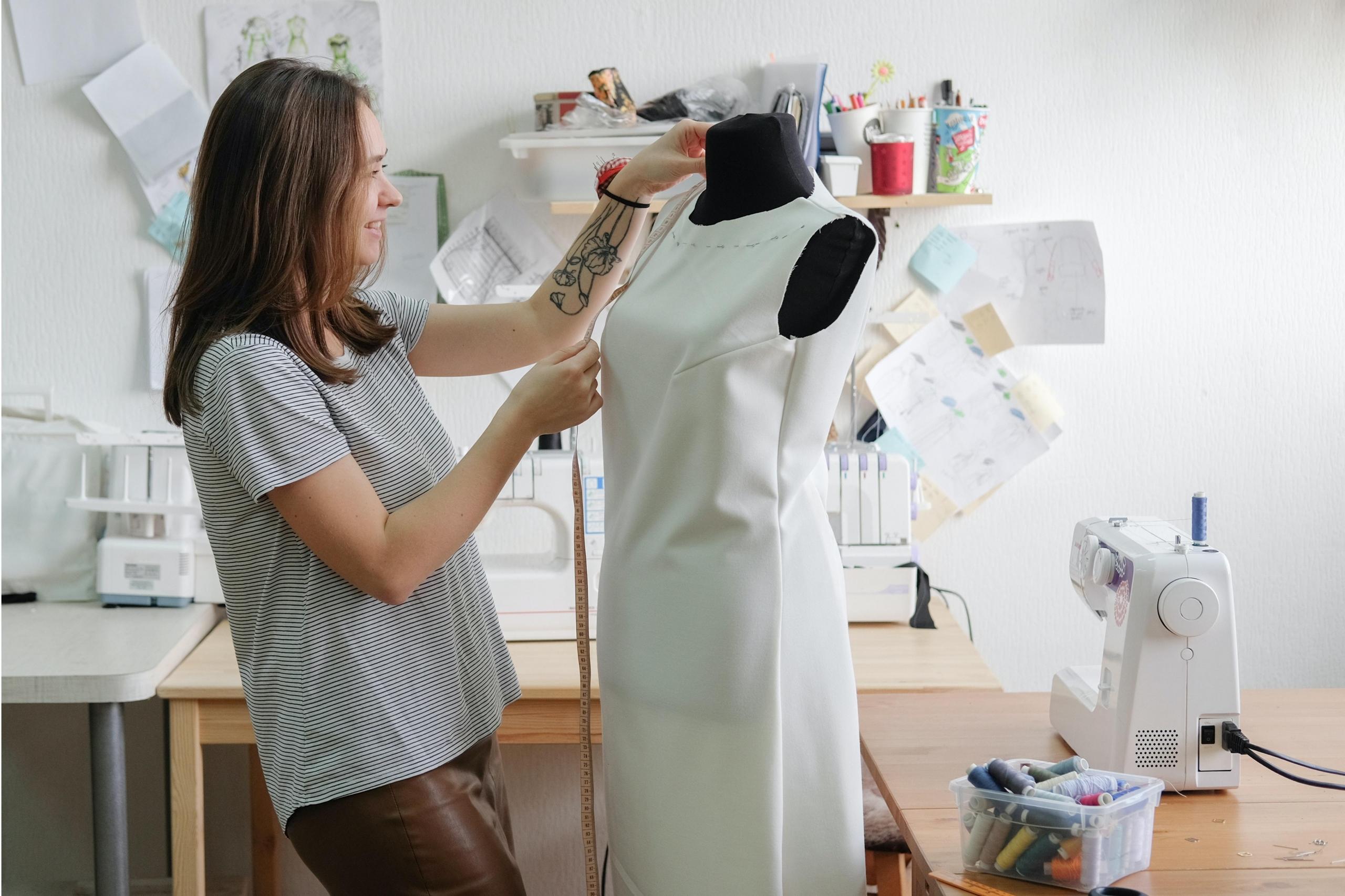 woman measuring and constructing garment