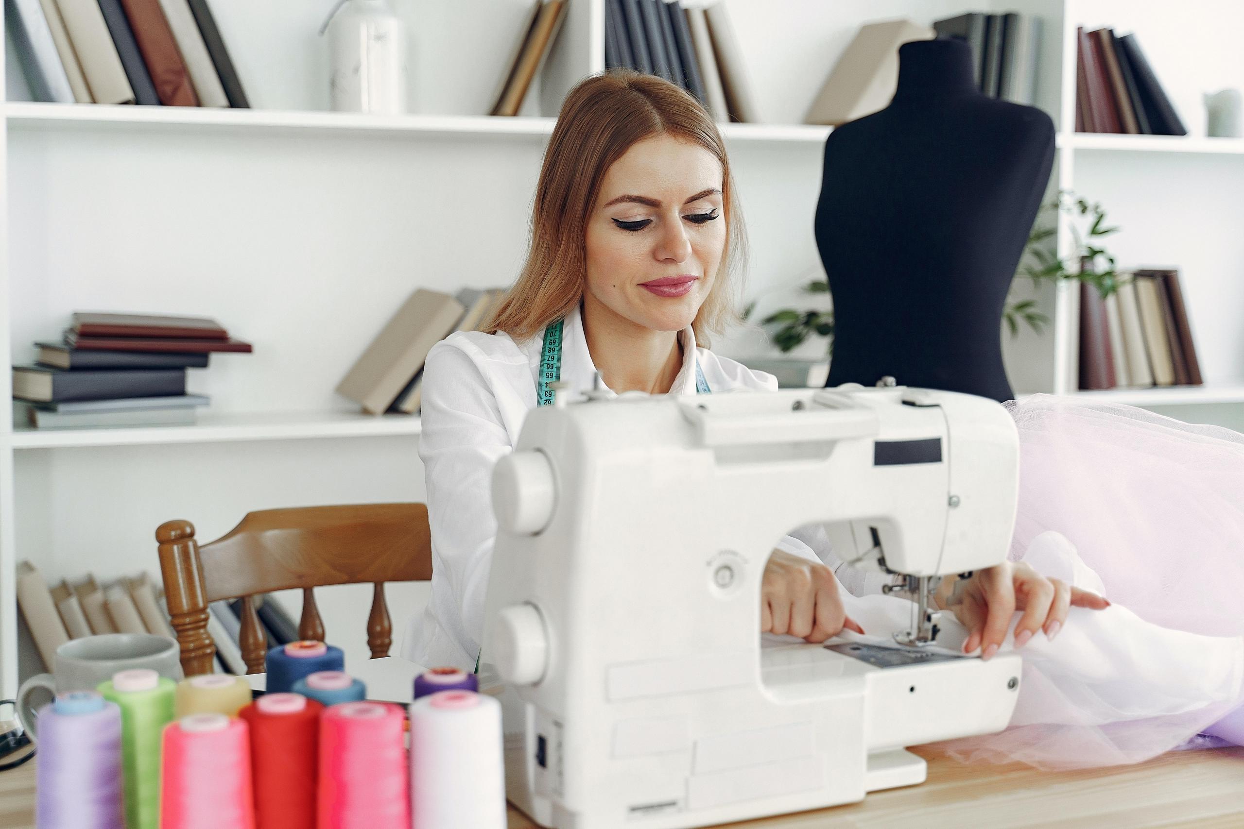 woman using sewing machine