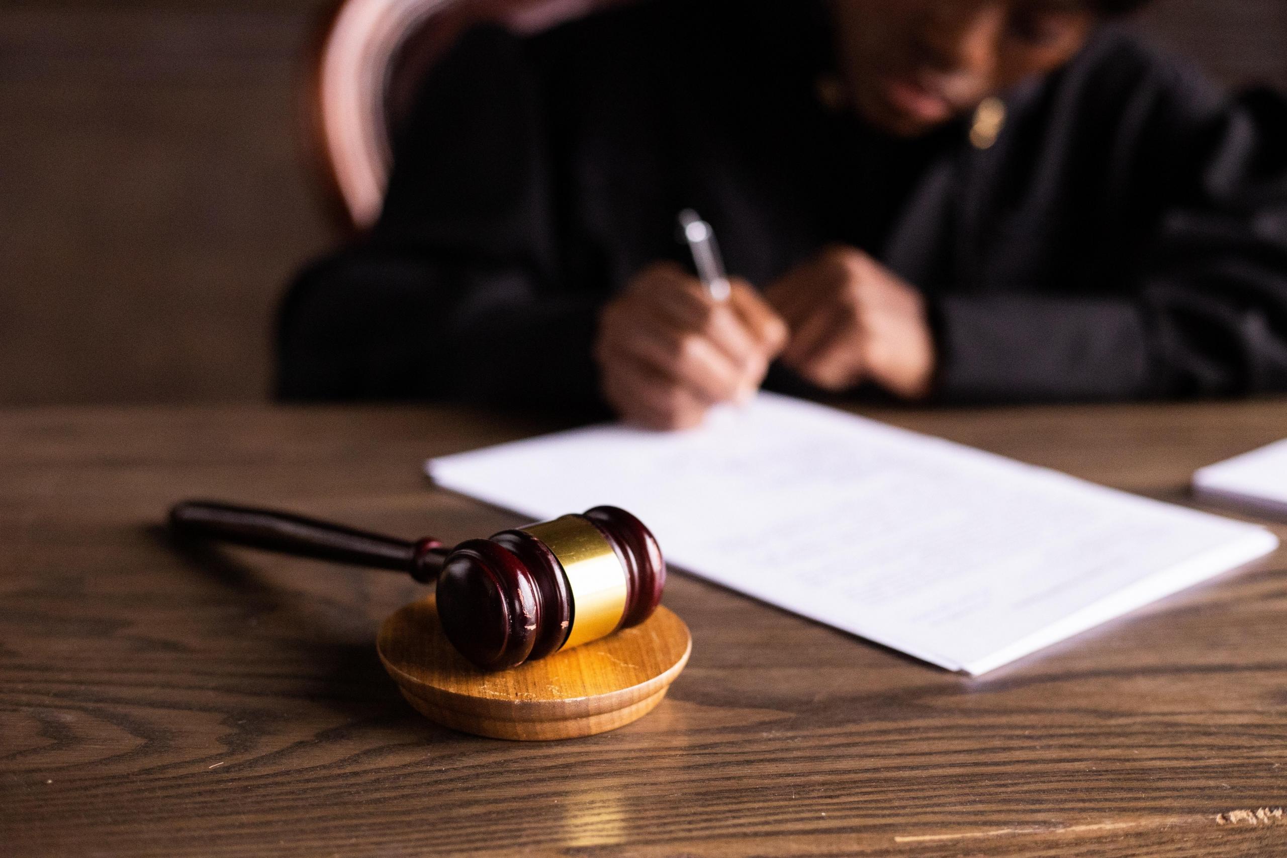 judge working at desk with gavel