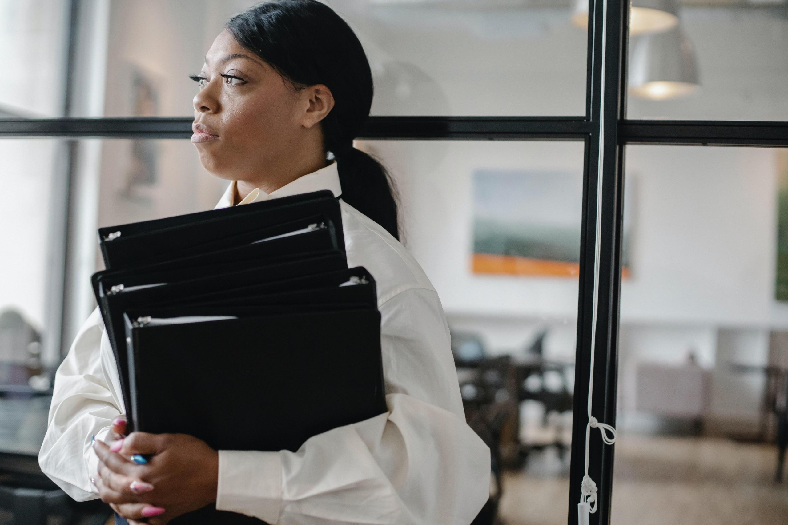 well-dressed woman carrying folders