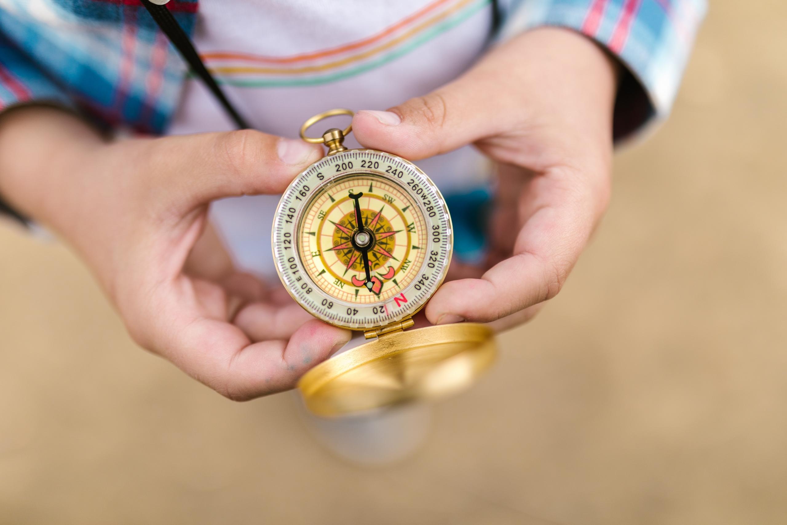 child consulting compass directions