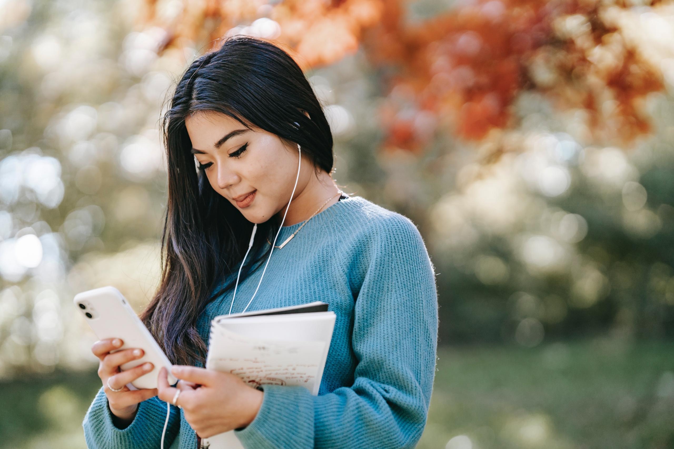 woman using headphones and smartphone