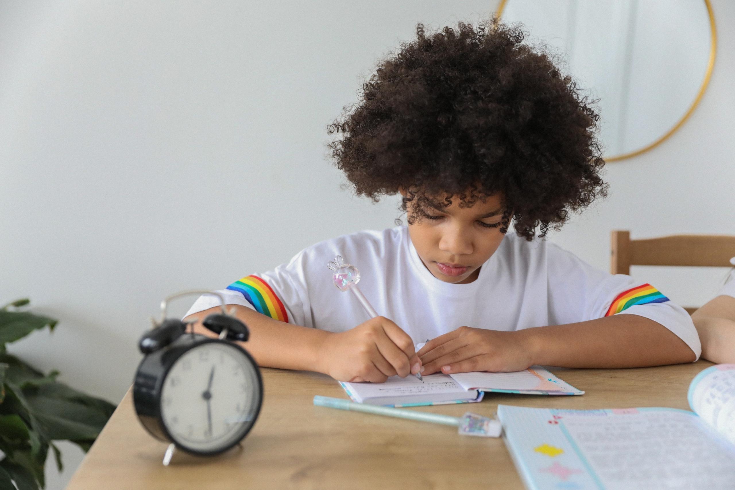 young child busy with school homework at desk
