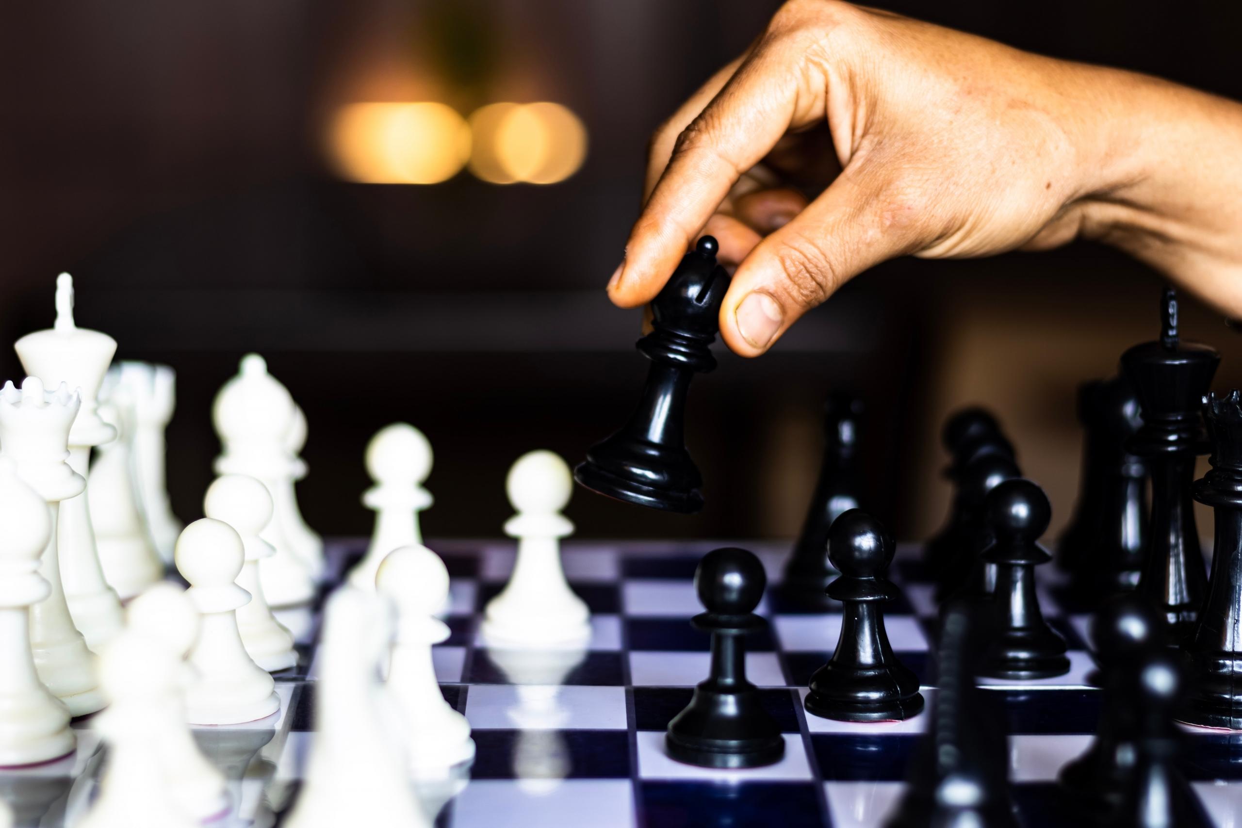 person moving chess pieces
