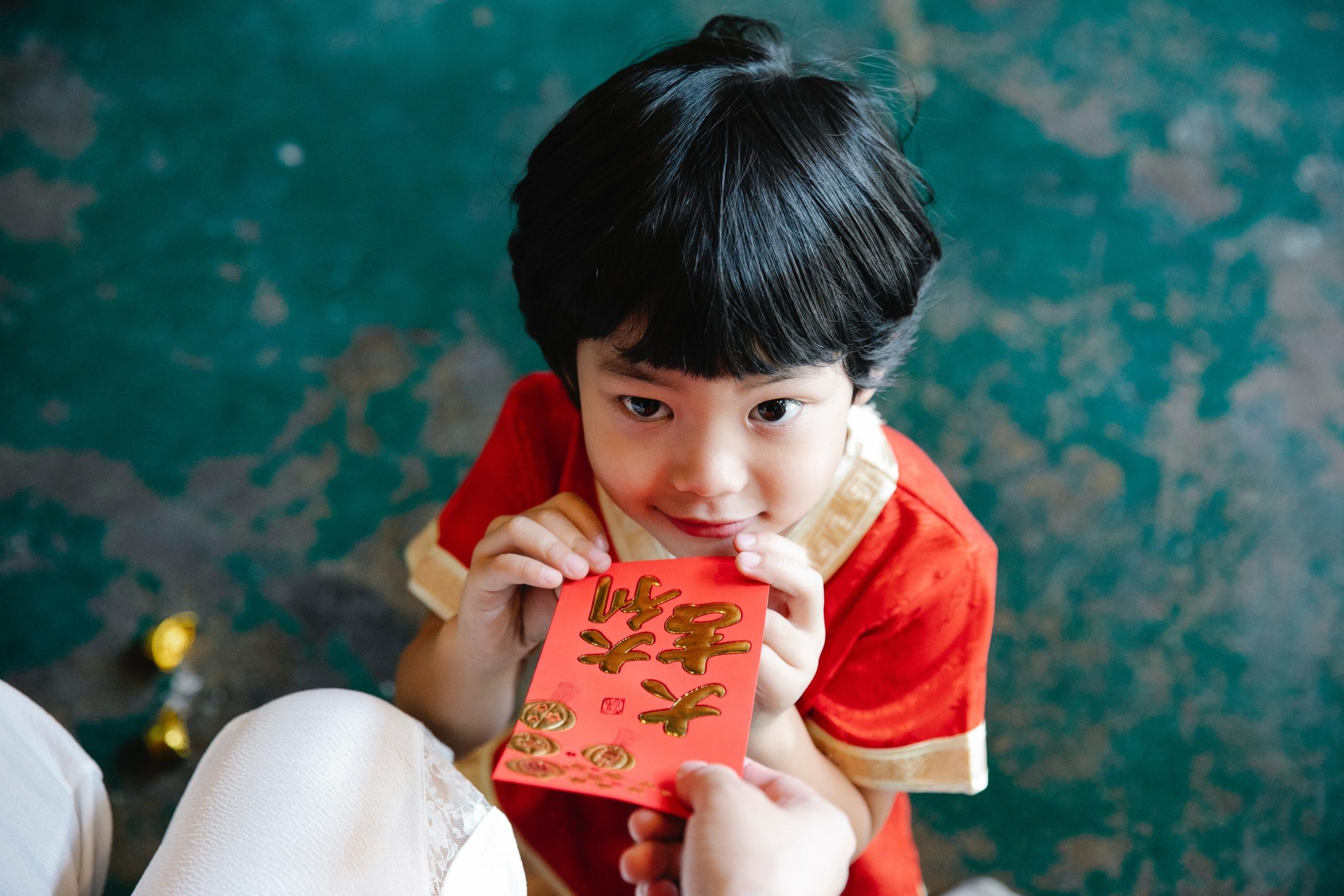 boy holding read Chinese New Year card