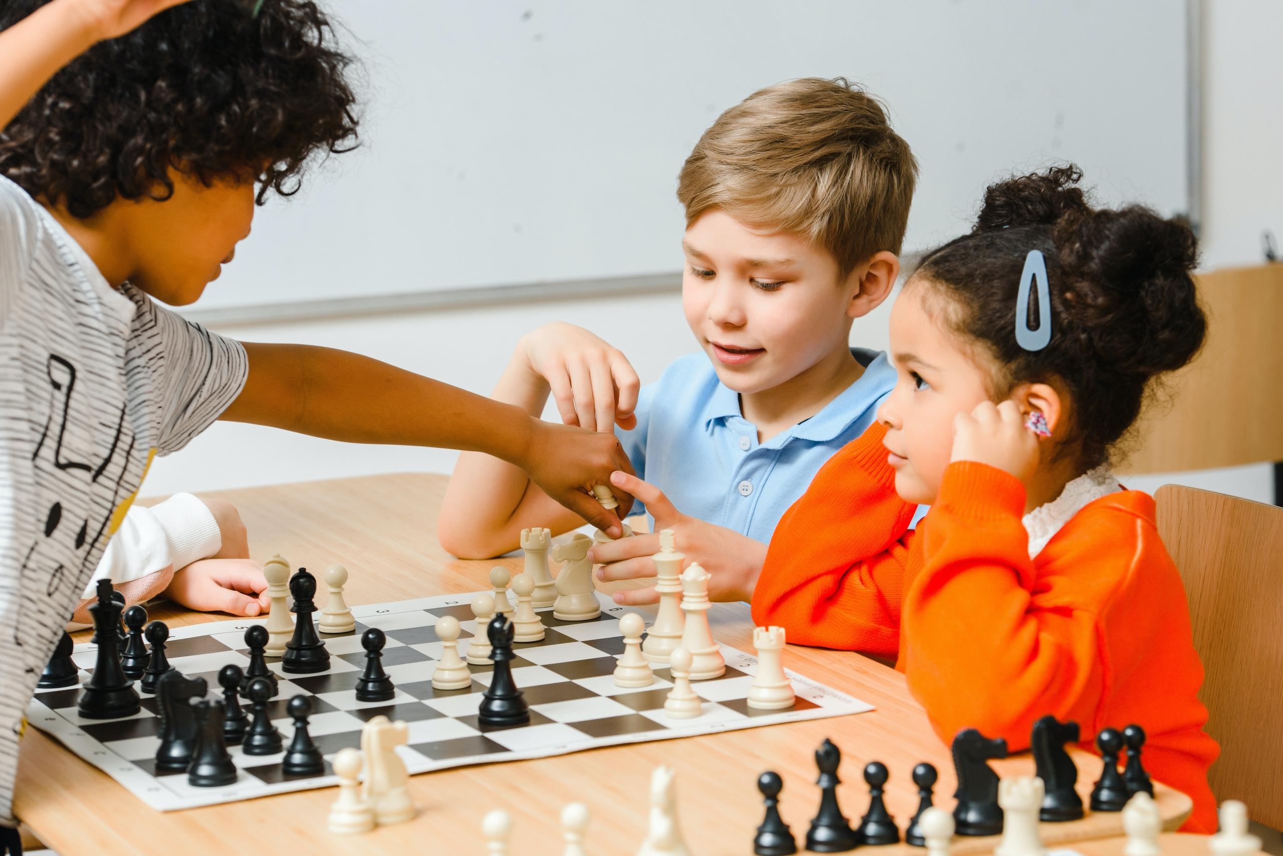 young children learning to play chess
