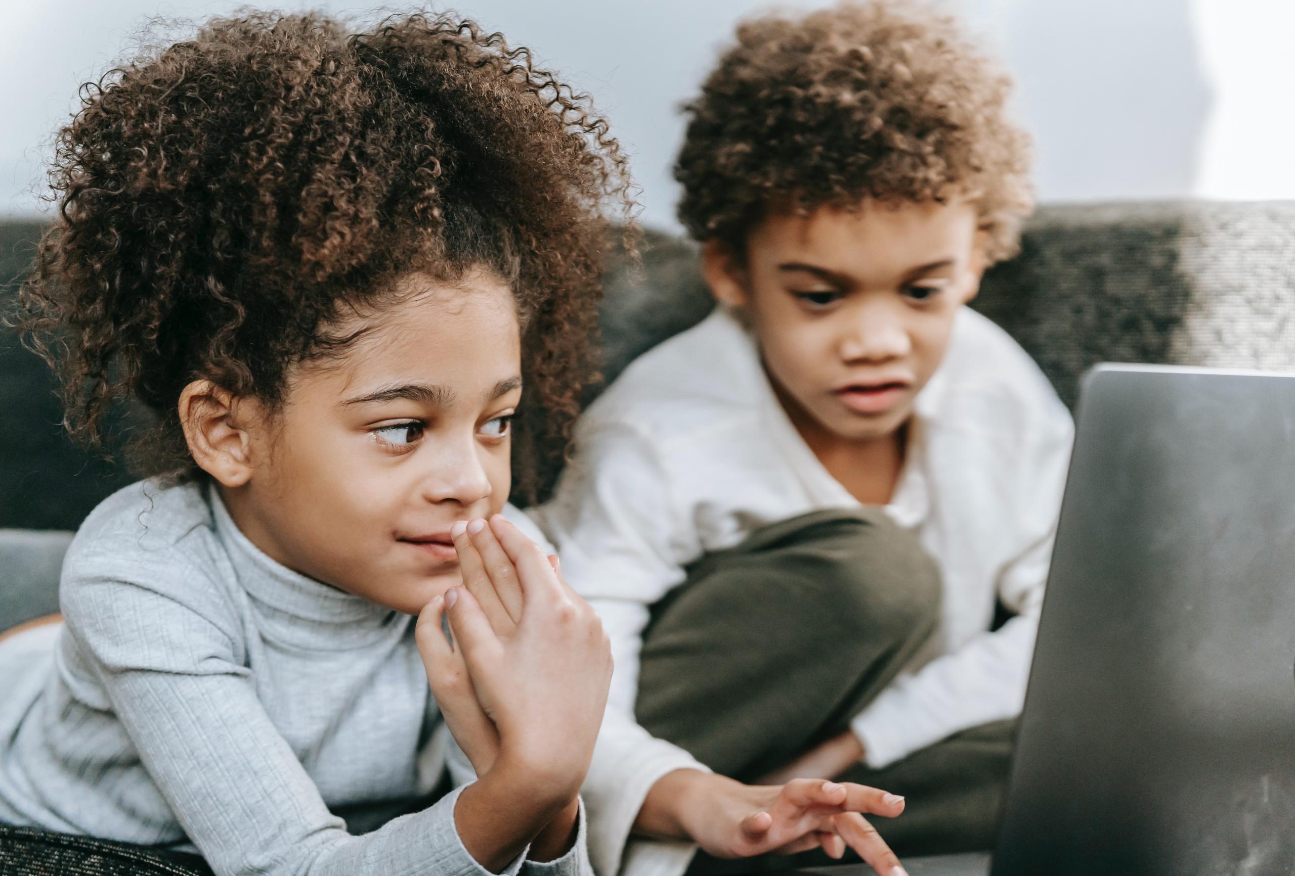 brother and sister playing with computer