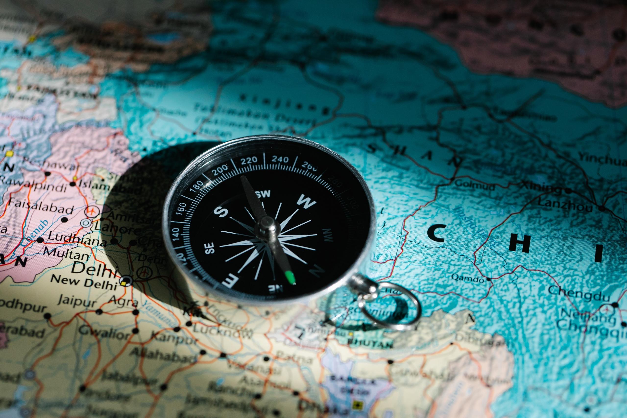 direction compass placed on world map