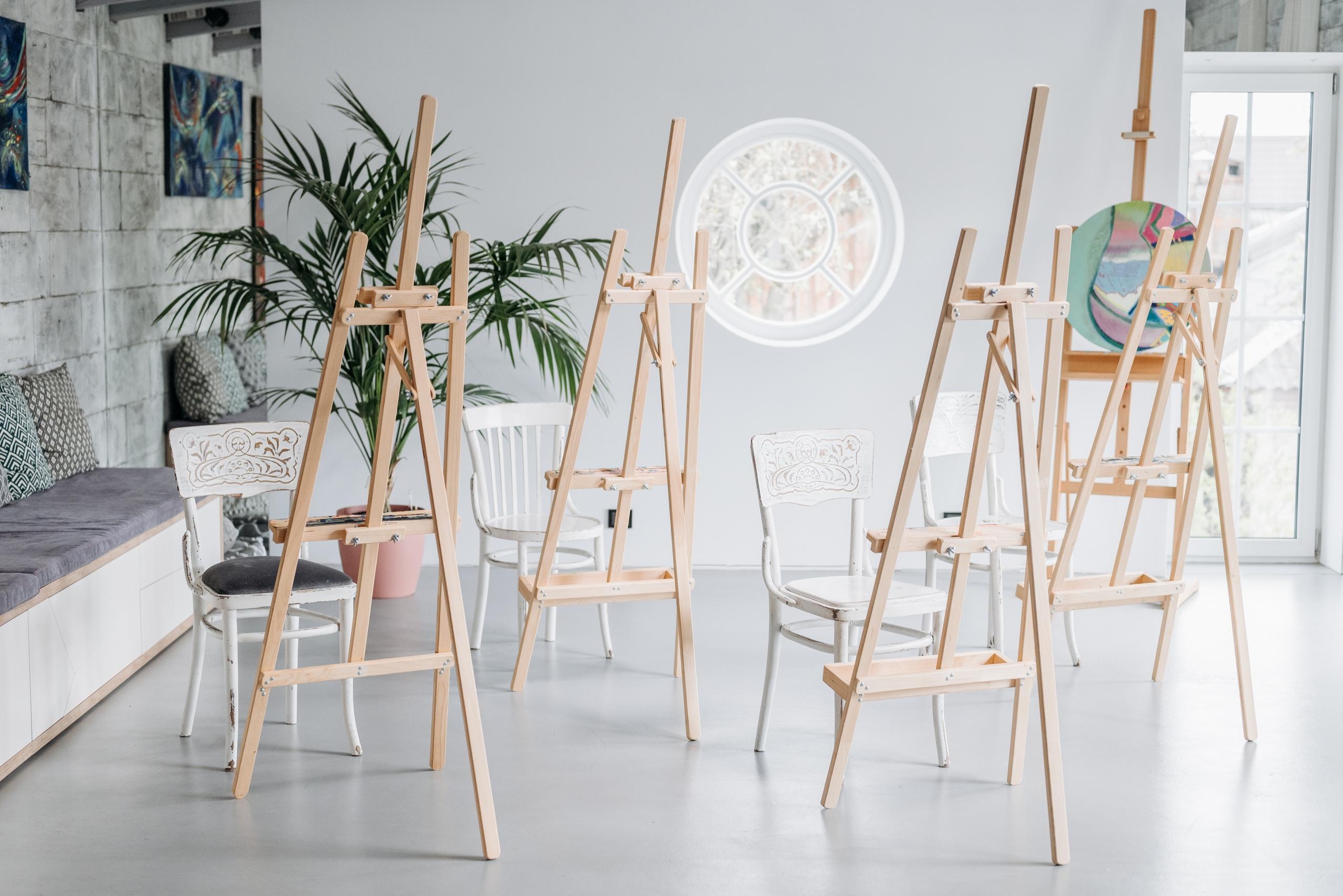 row of easels set up in artist's studio
