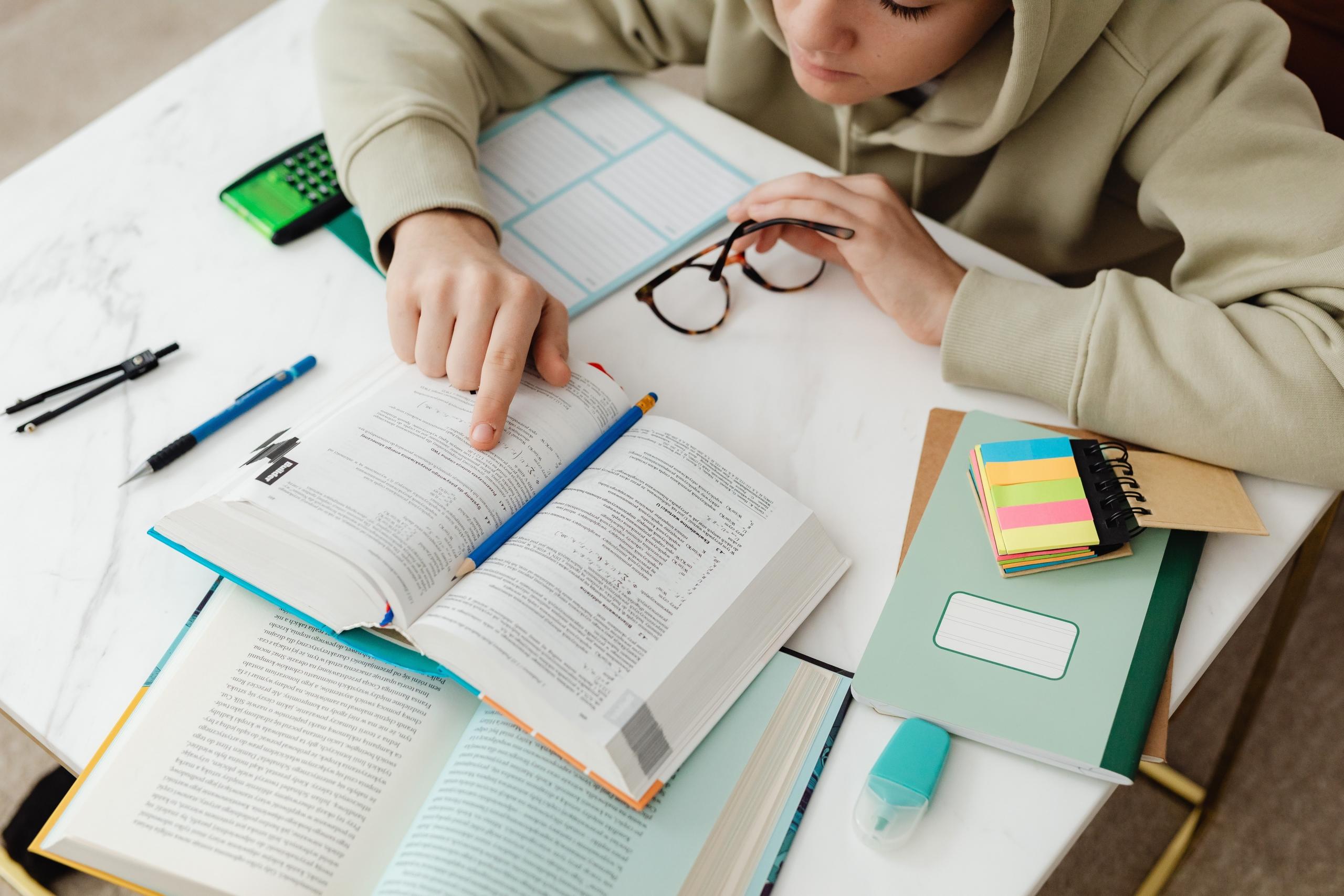 teen reading textbook