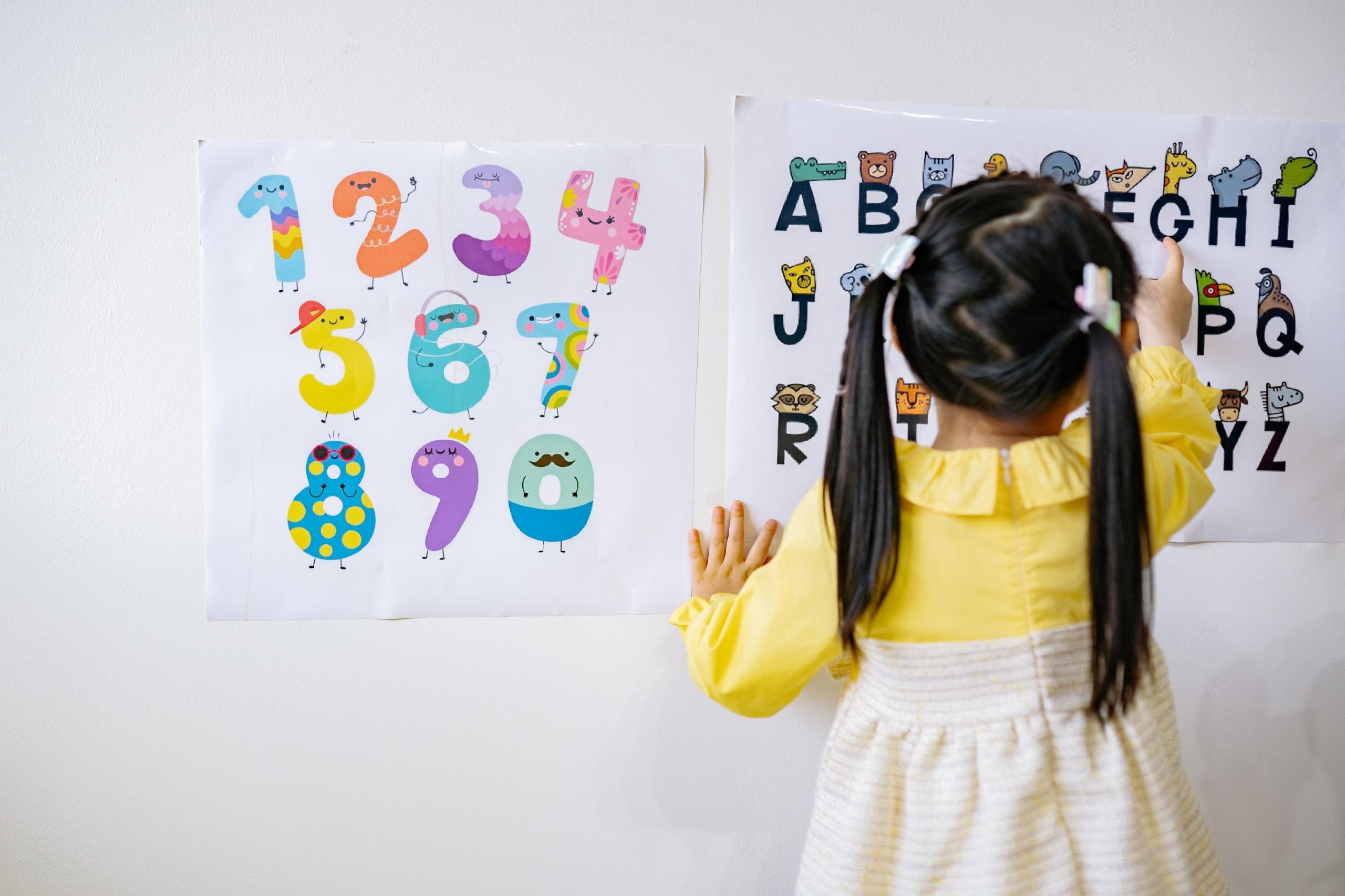 young girl learning to count using charts