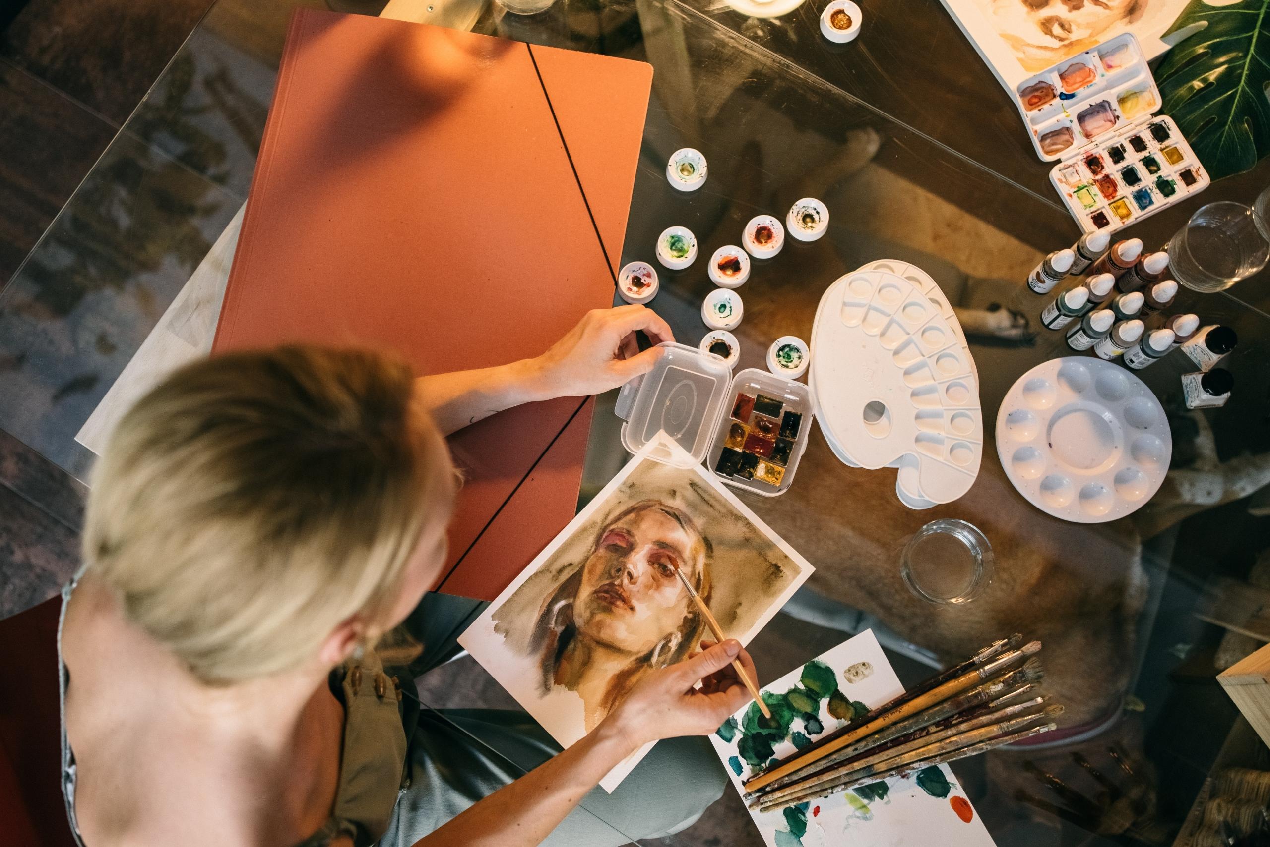 artist creating watercolour painting of woman