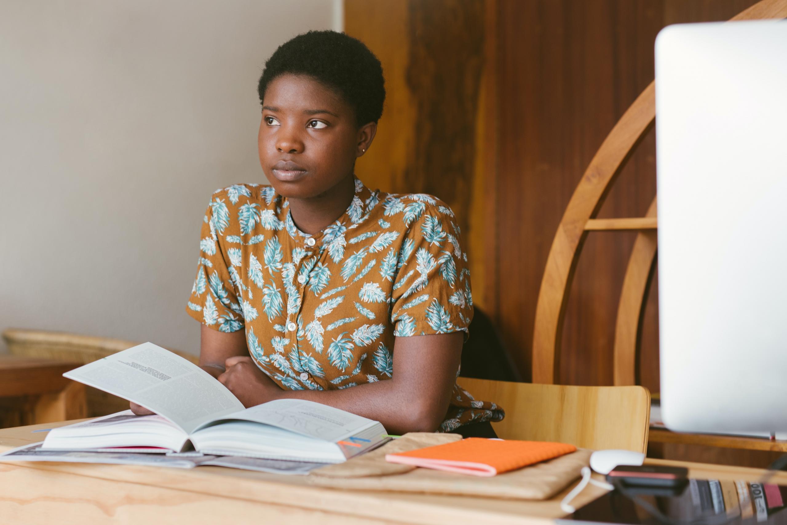 student revising for exams, using textbooks and notebooks