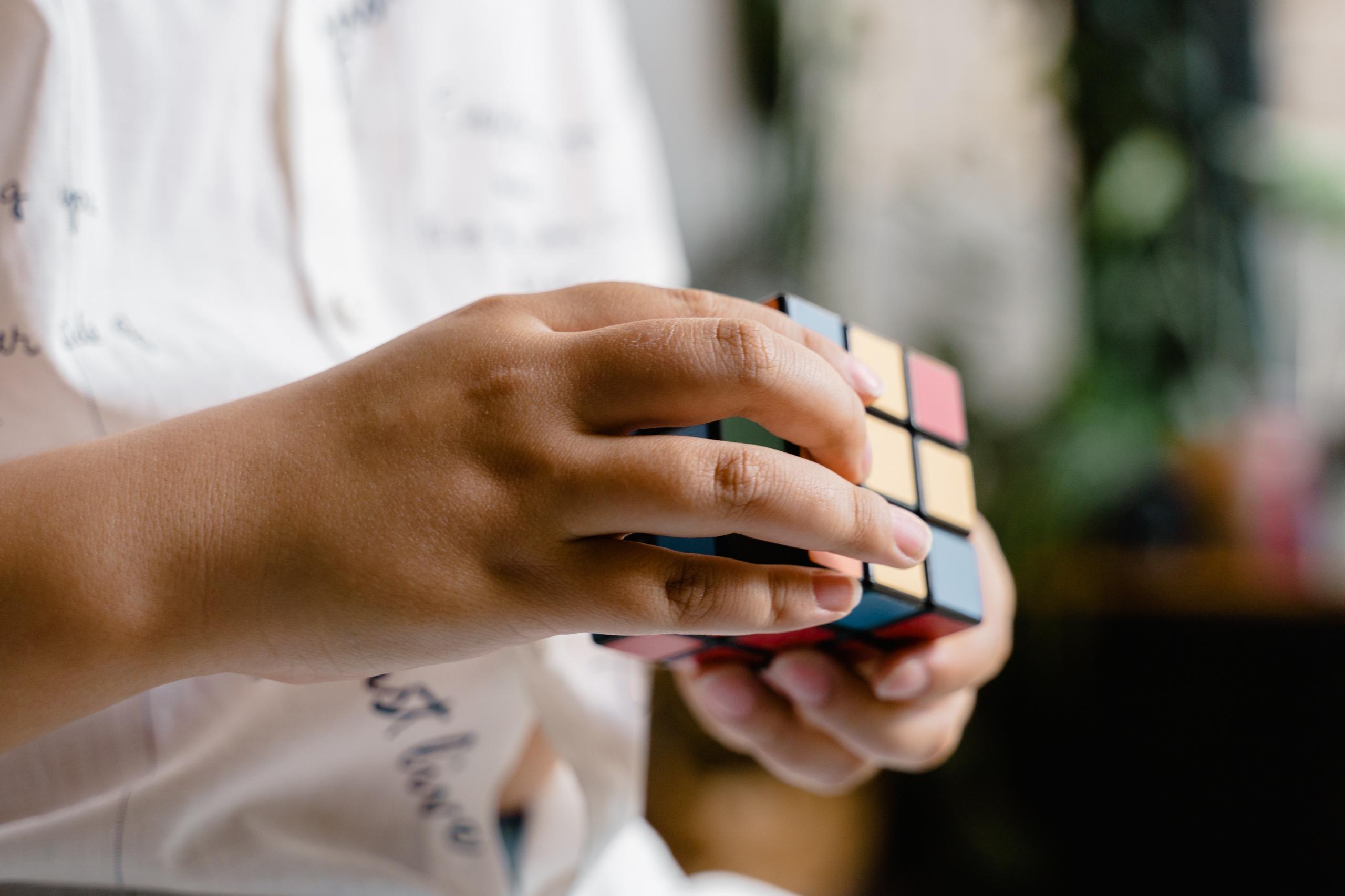 child trying to solve a rubik's cube