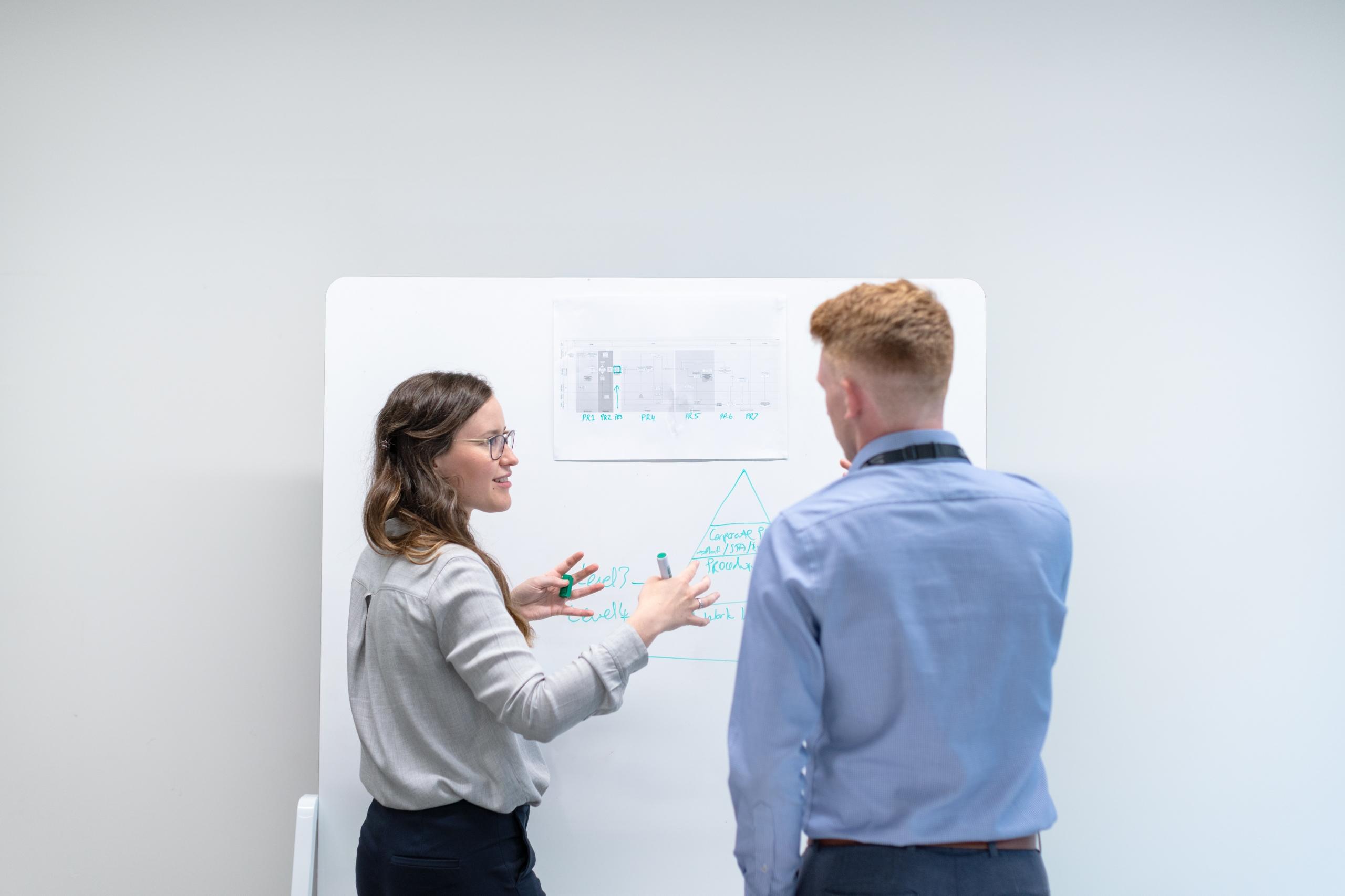 Female accountant discusses data in meeting with colleague-unsplash