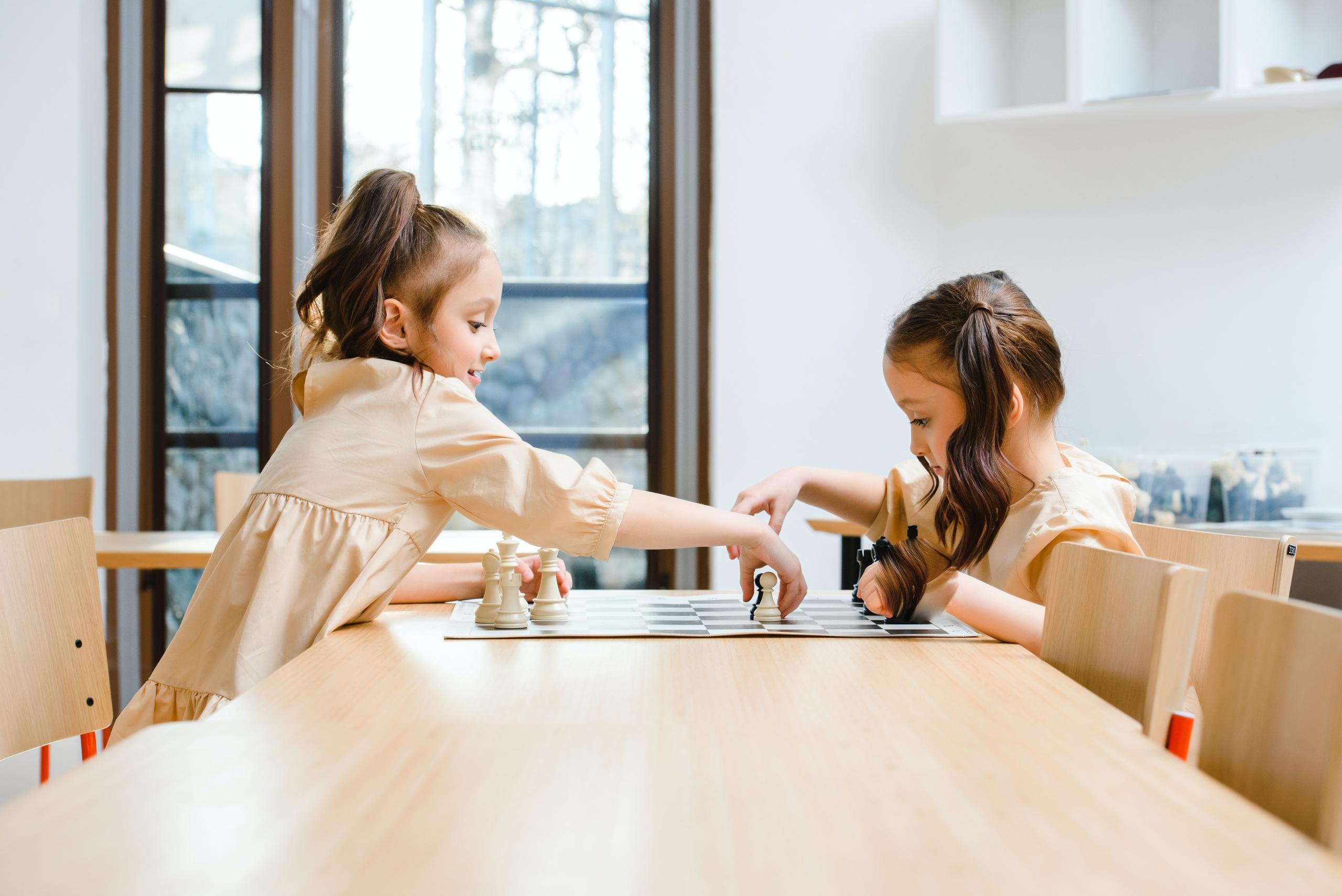 sisters learning to play chess