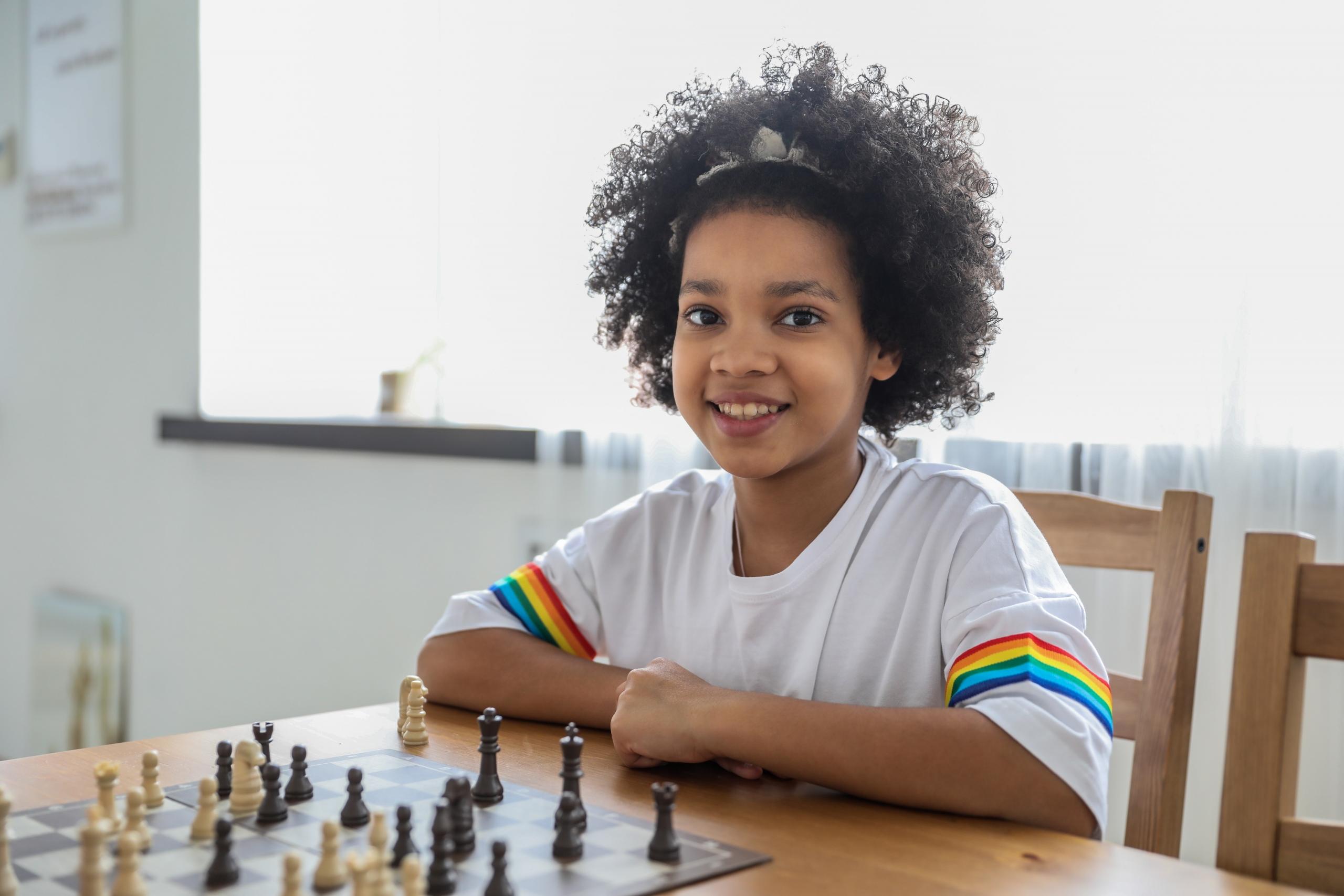 girl learning to play the game of chess