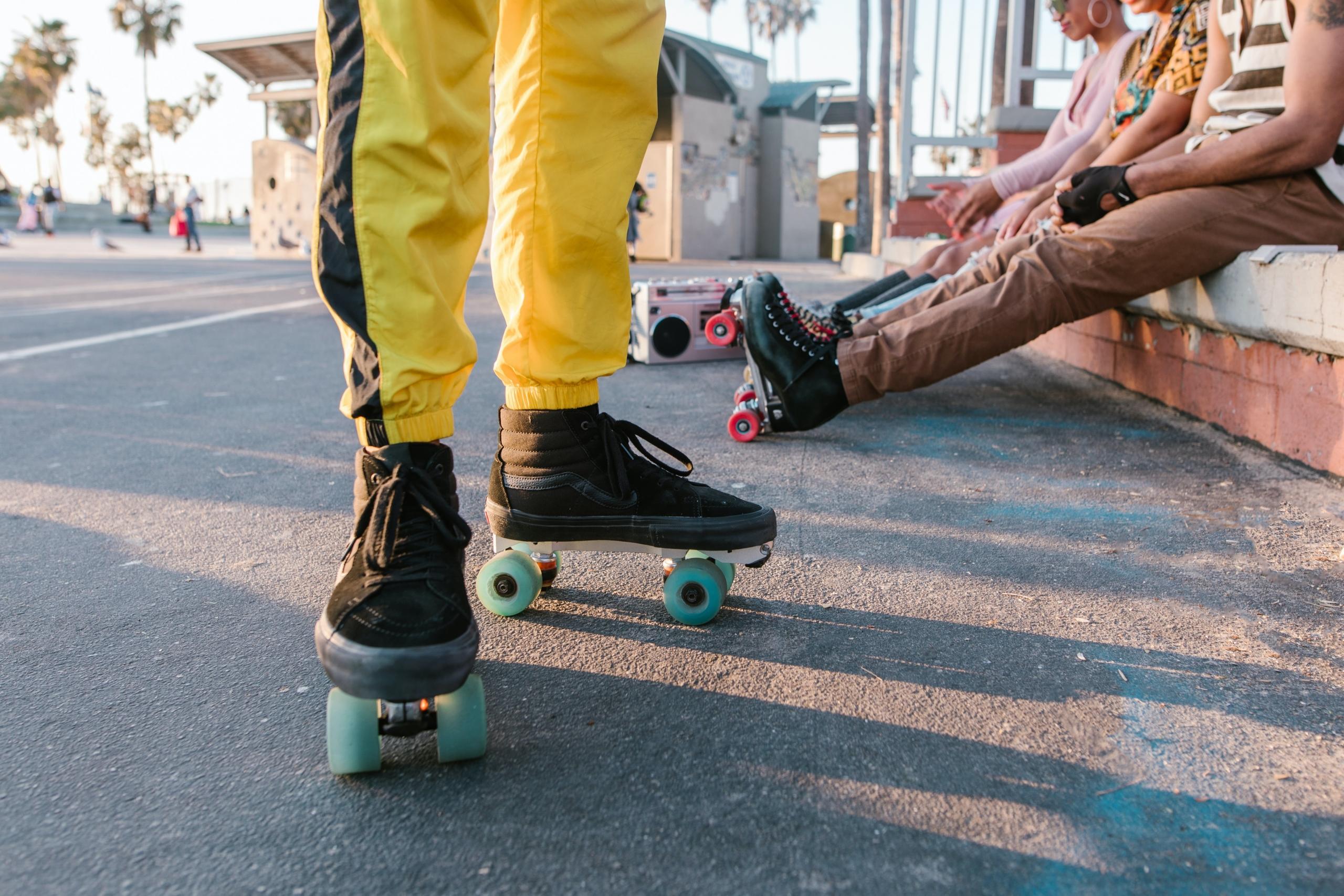 friends wearing roller skates at outdoor skate park