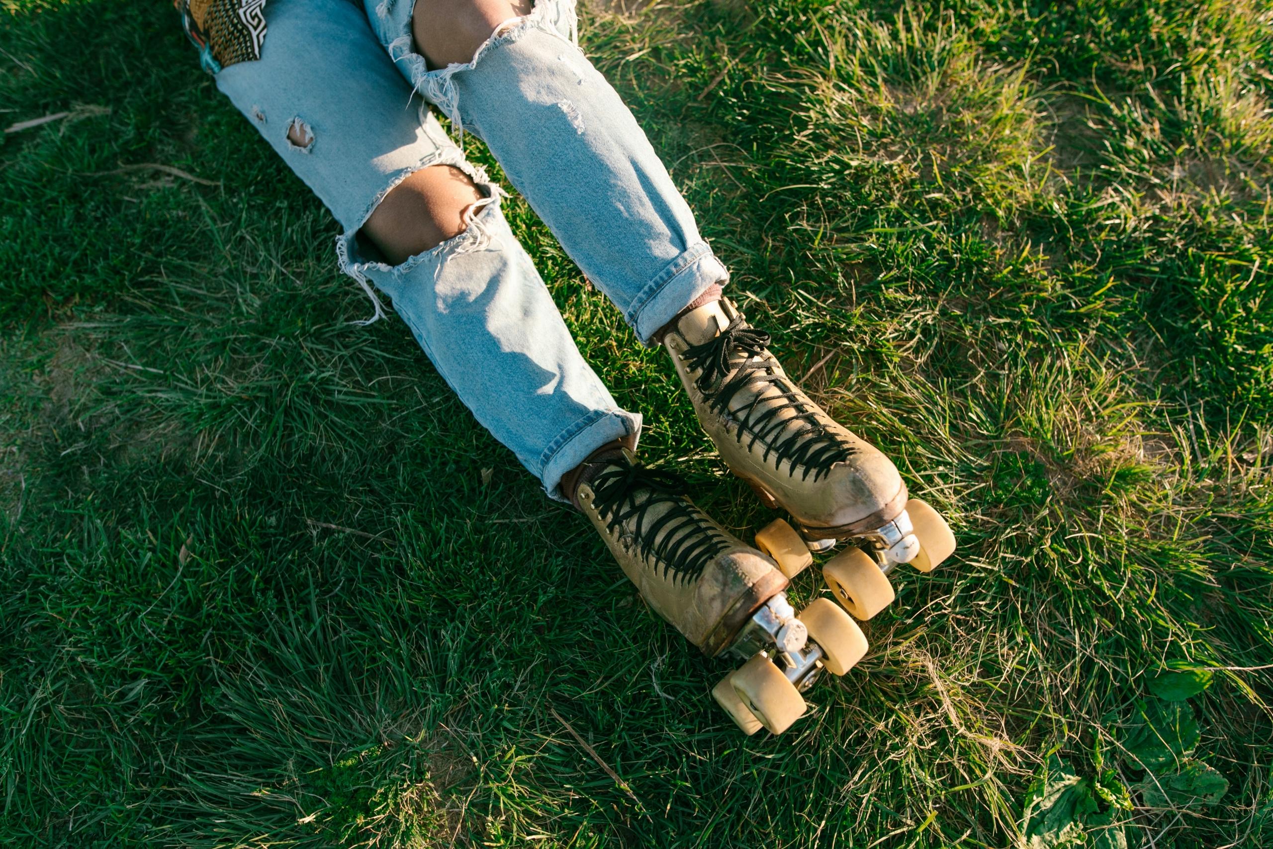 woman wearing ripped jeans and rollerskates