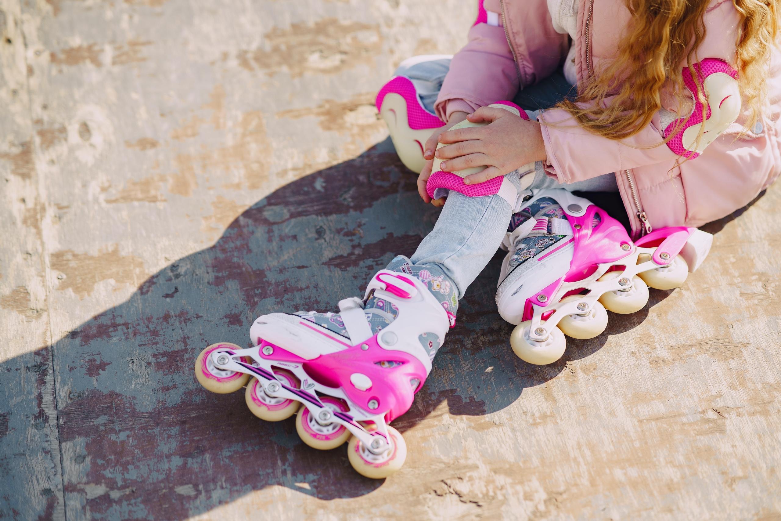 girl wearing pink and white rollerblades
