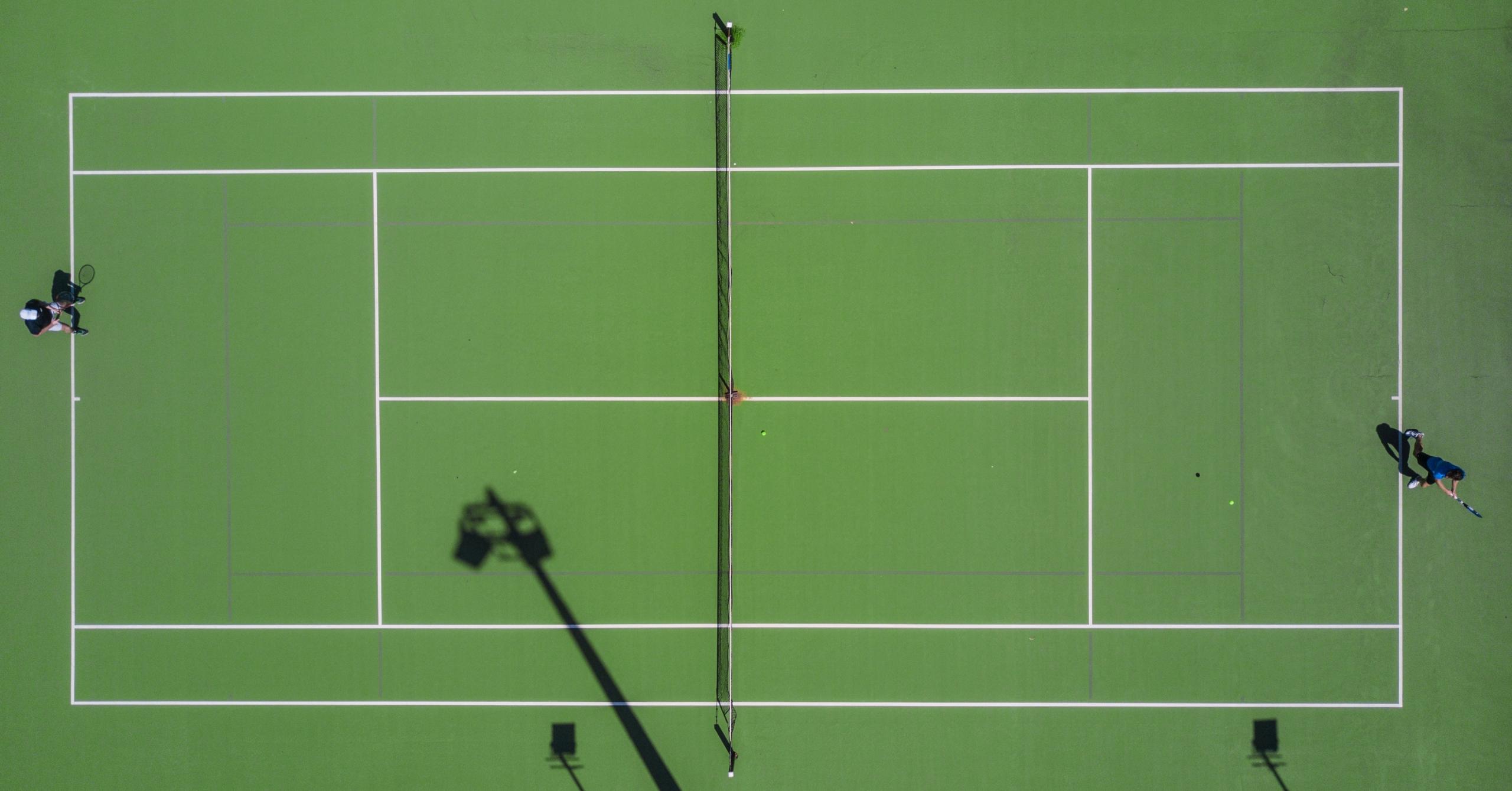 tennis game on grass tennis court