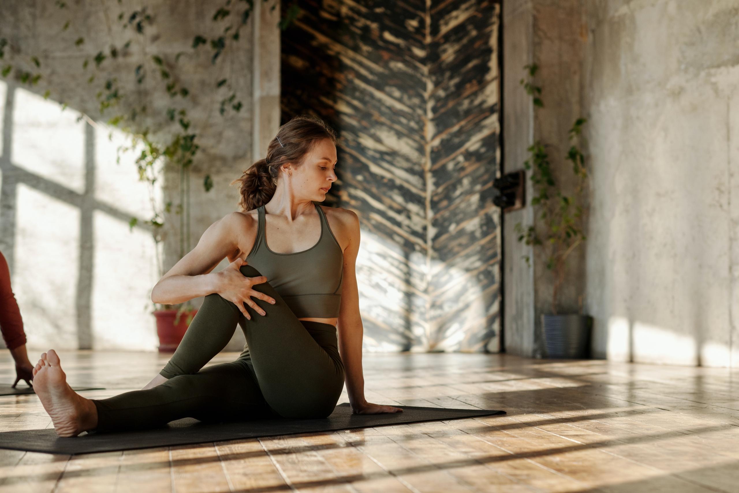 woman performing seated twist yoga asana