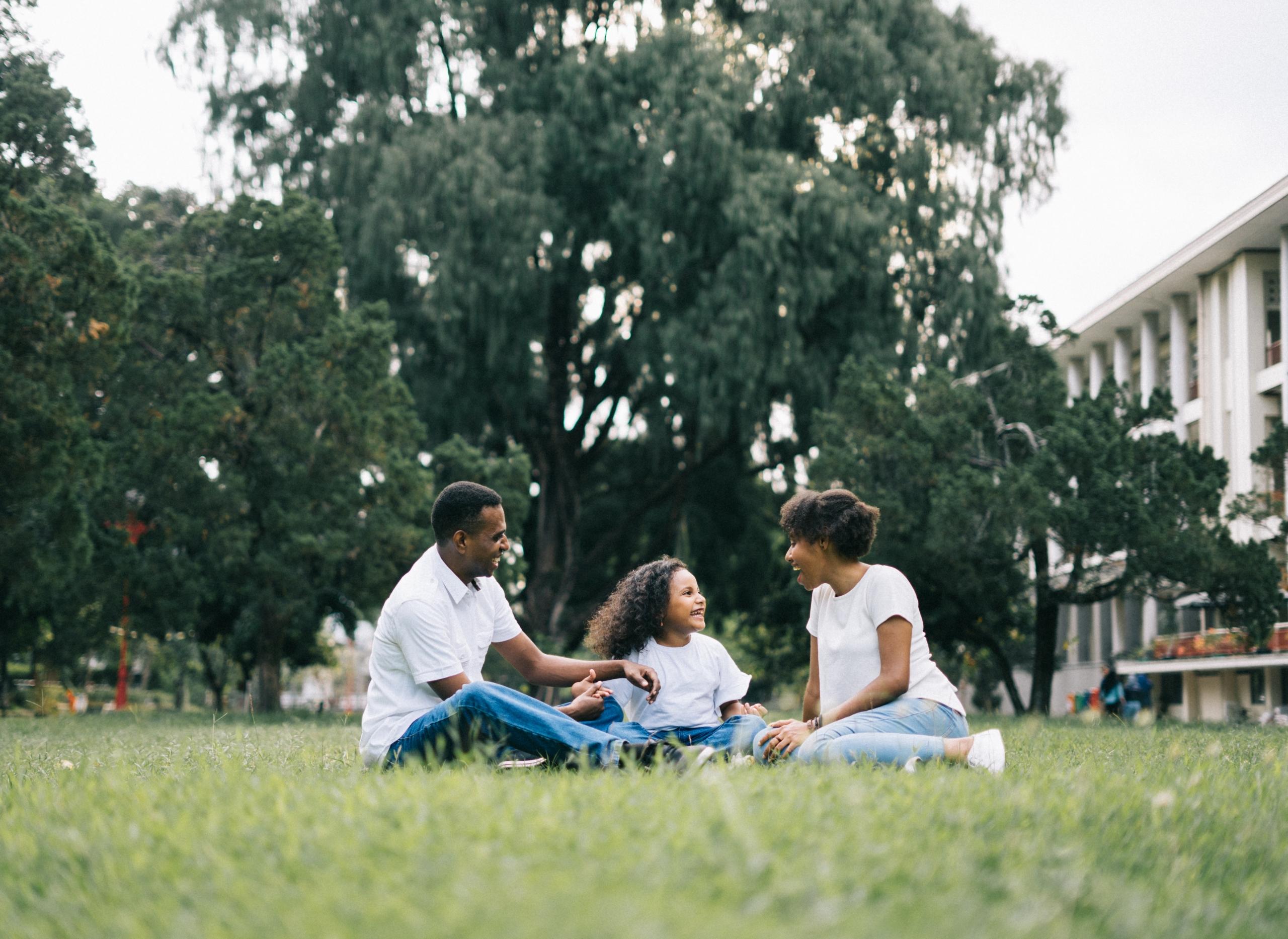mom, dad and child having picnic outdoors