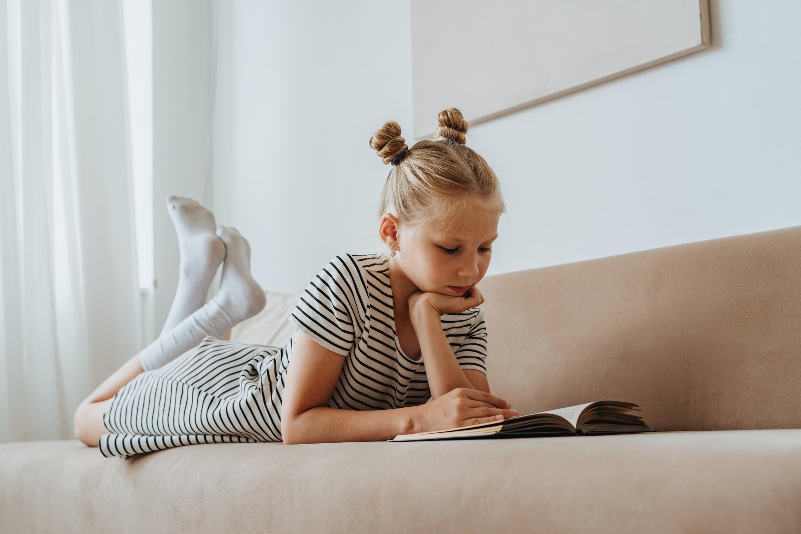 young girl reading a book