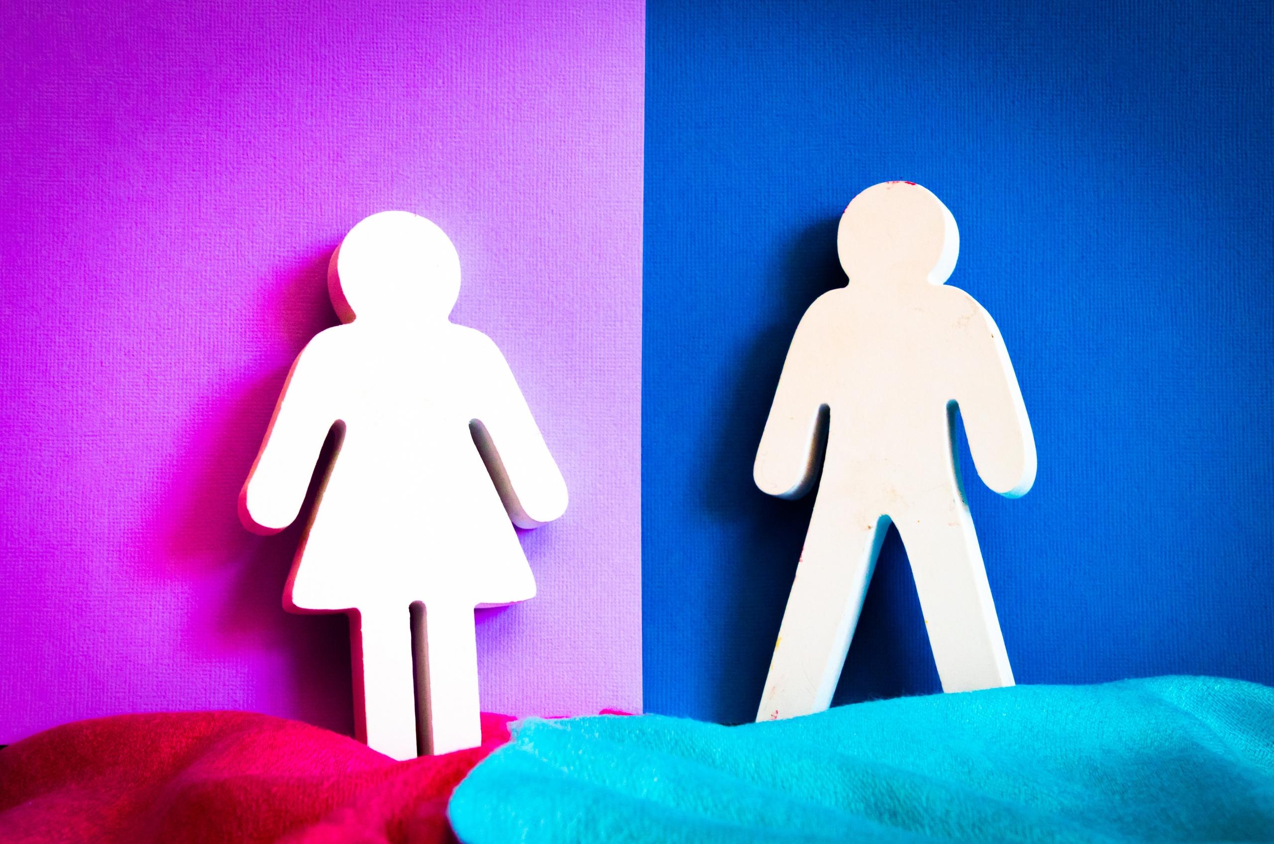 female and male signs against colourful backdrop