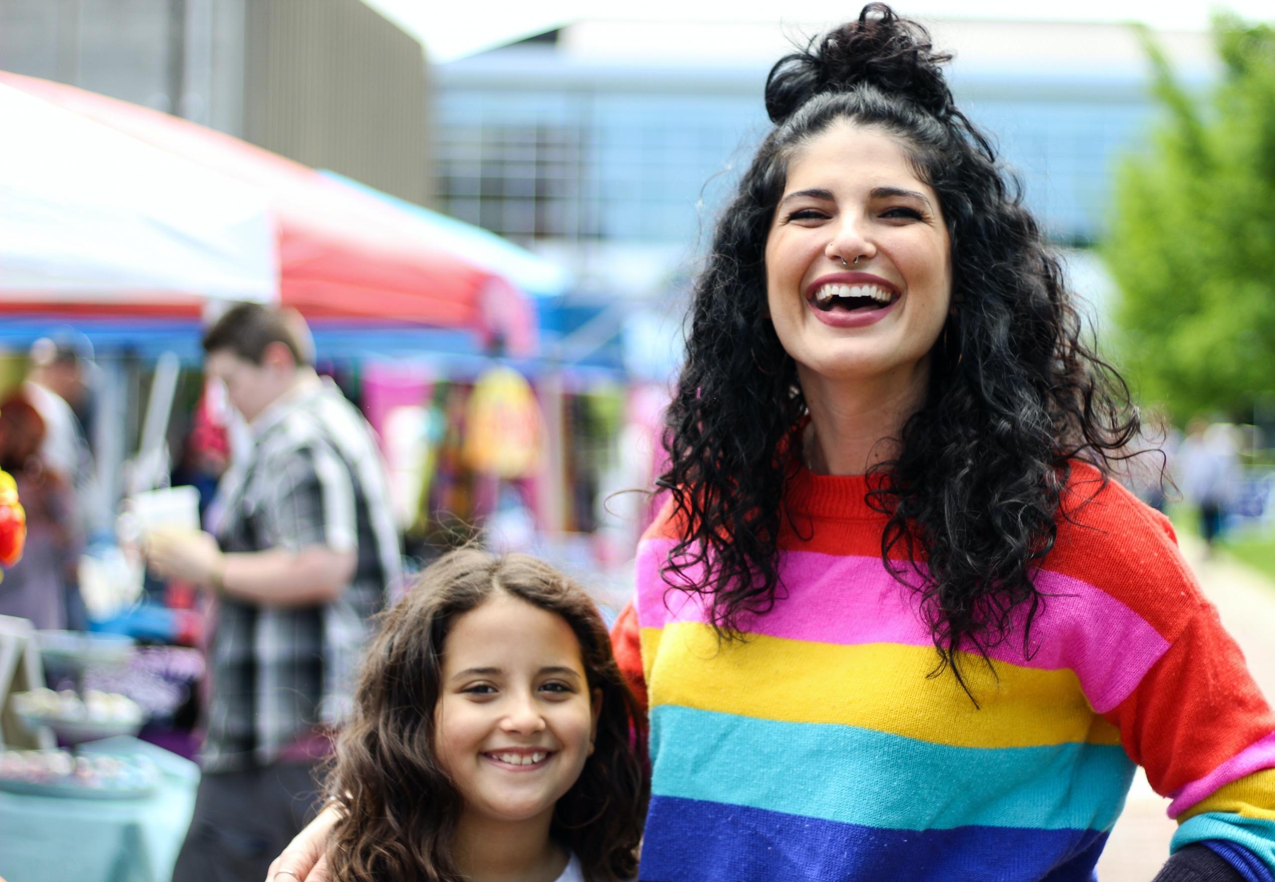 child with mother wearing pride jersey