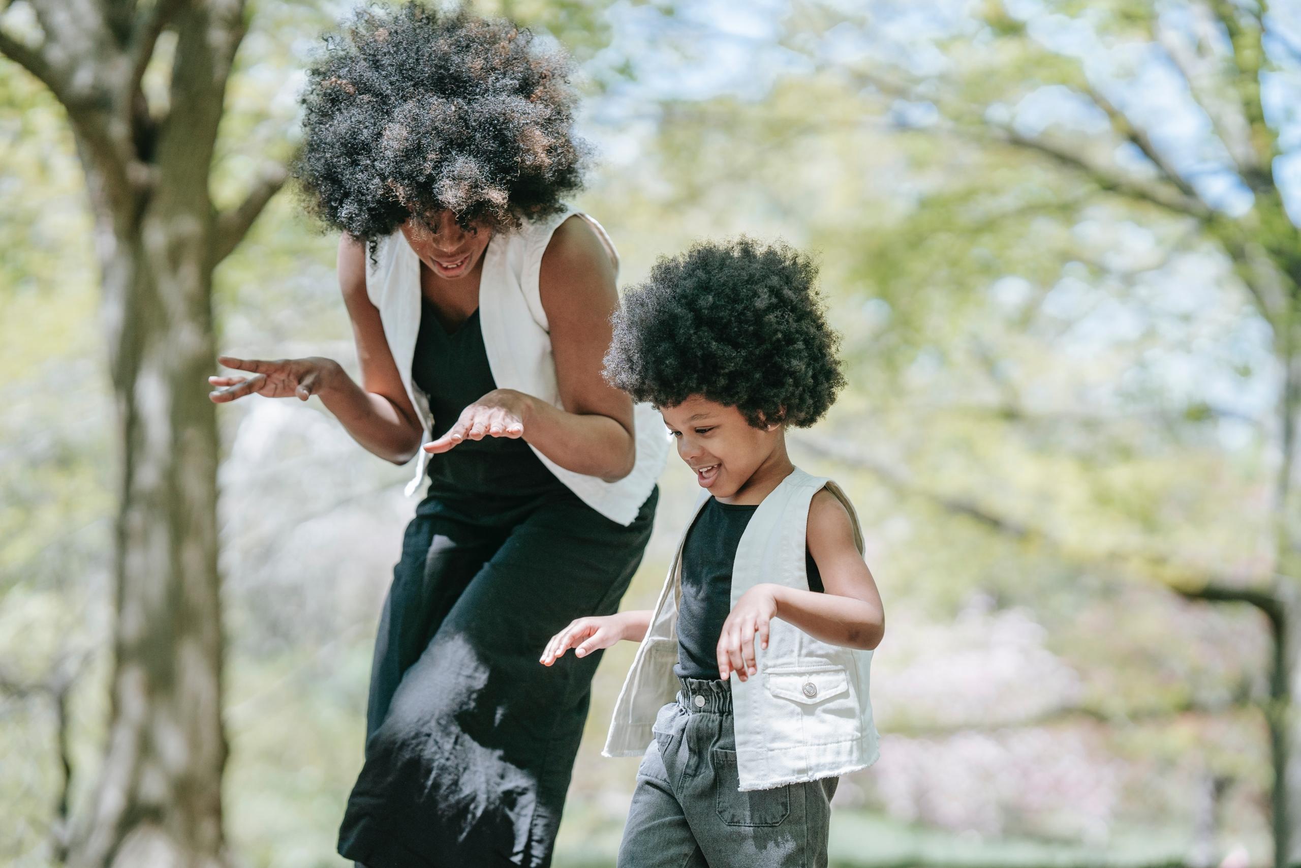 mother and child dancing outside