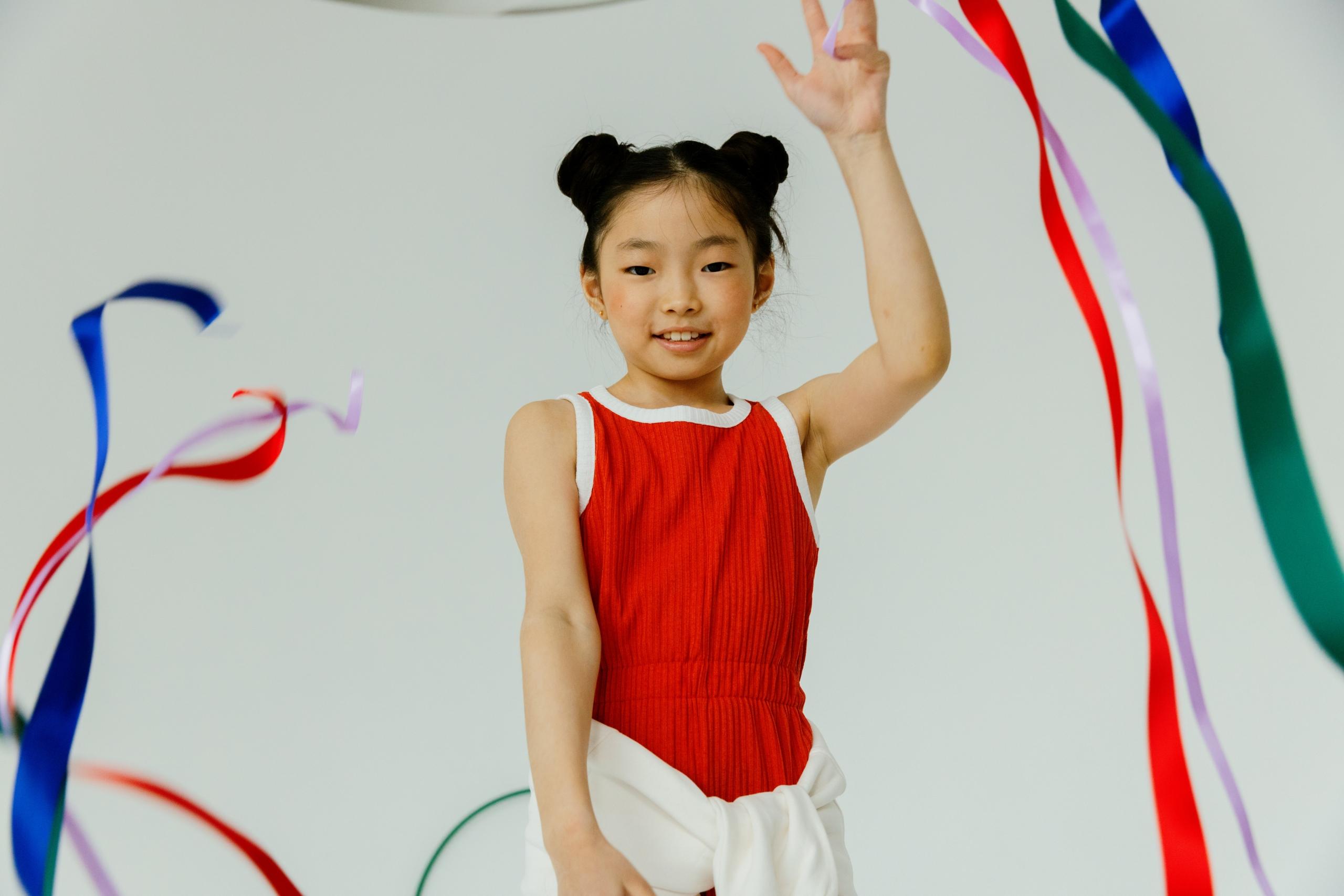 girl dancing with colourful ribbons