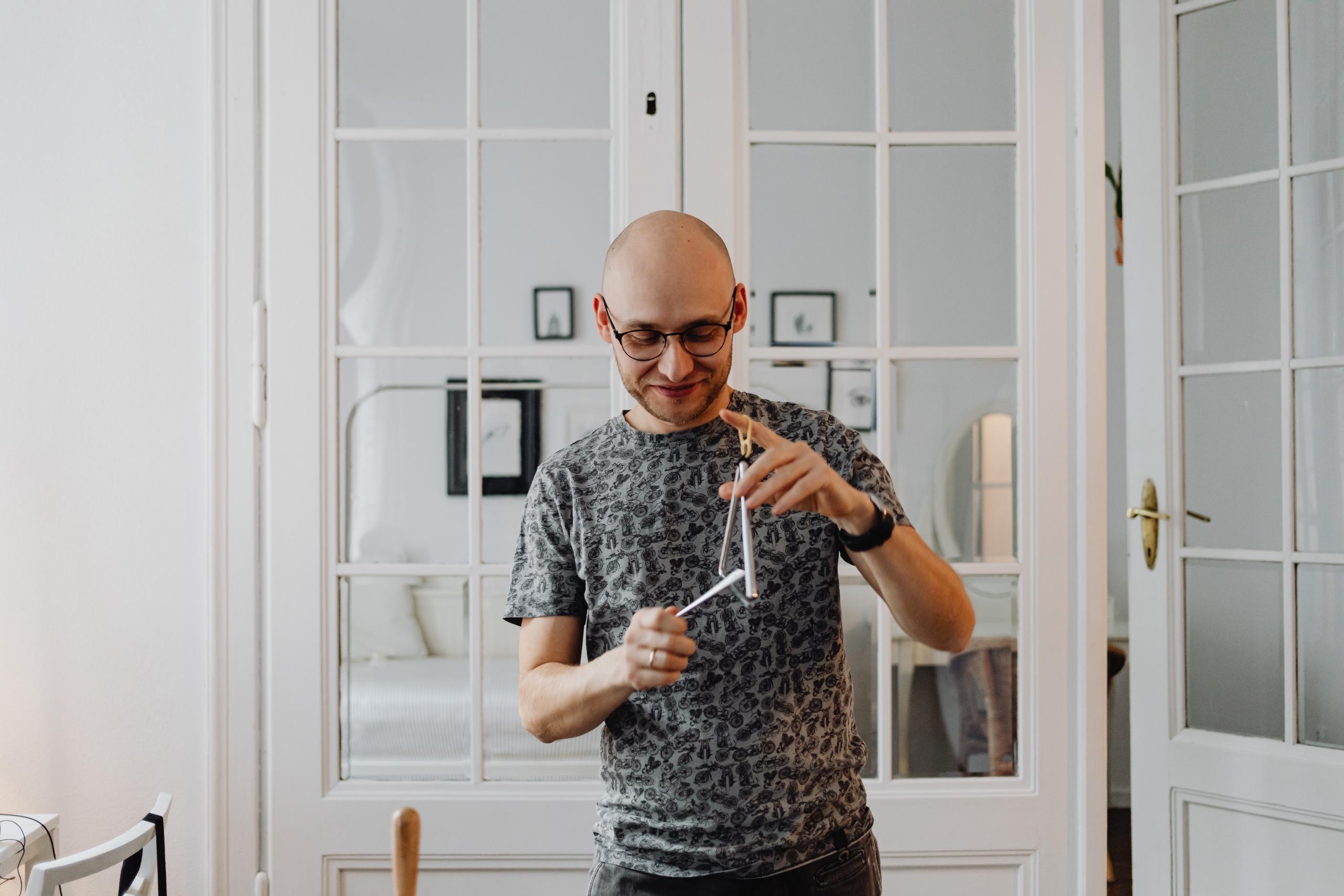 man playing the triangle at home