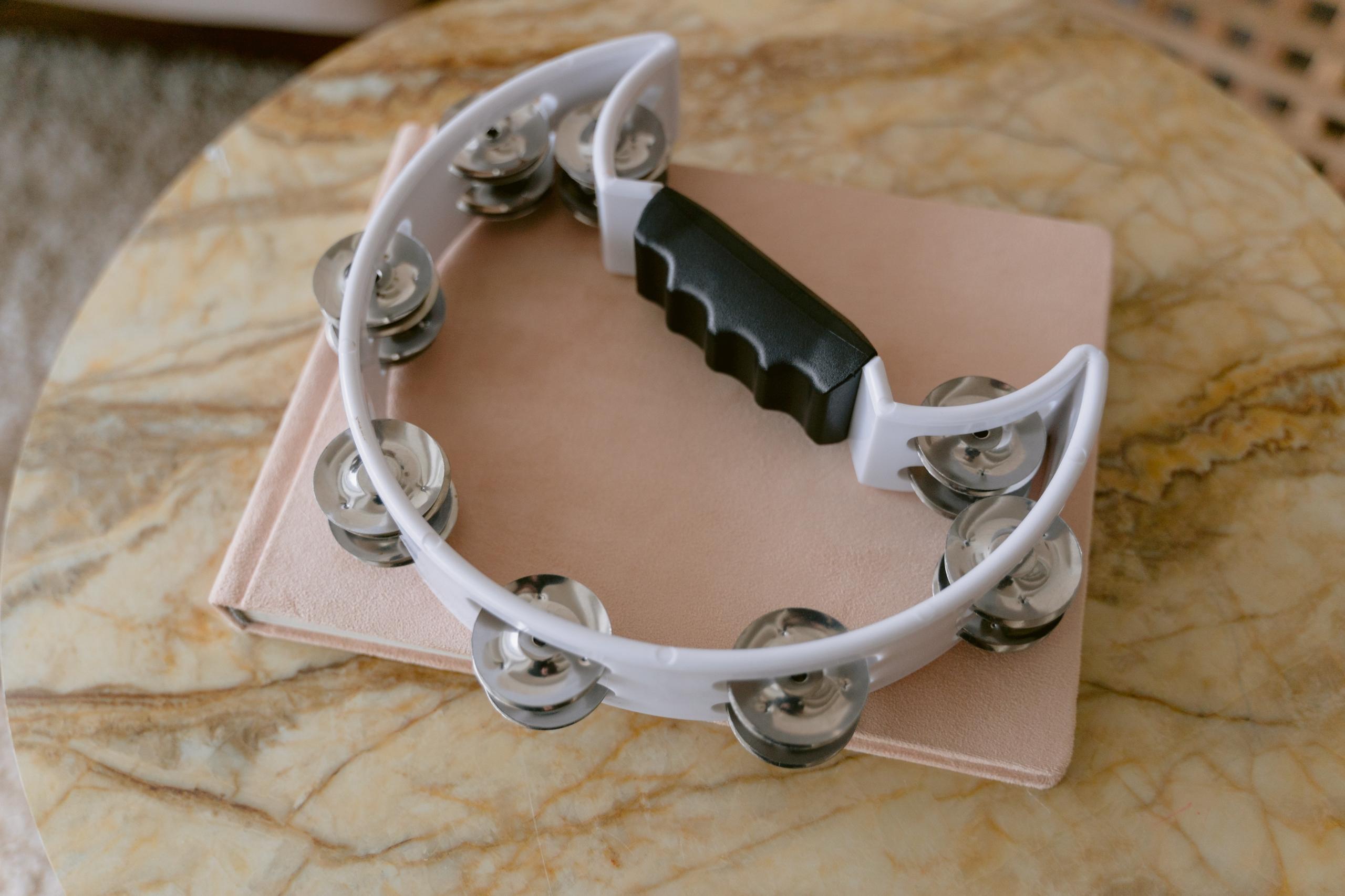 tambourine placed on top of book on table