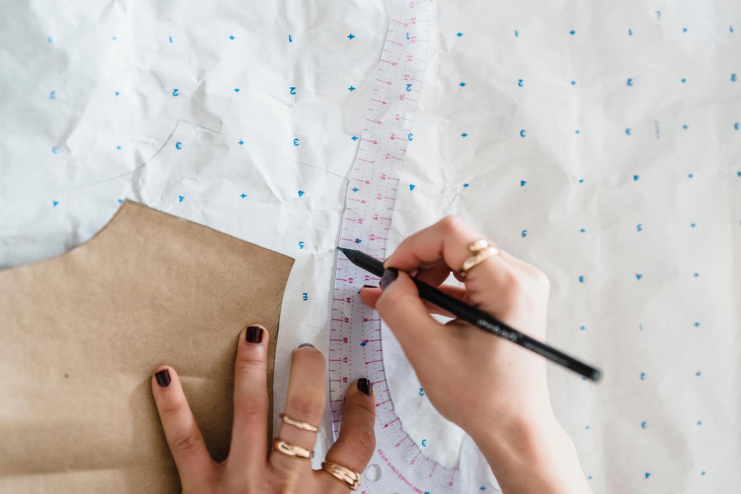 dressmaker drawing pattern onto fabric