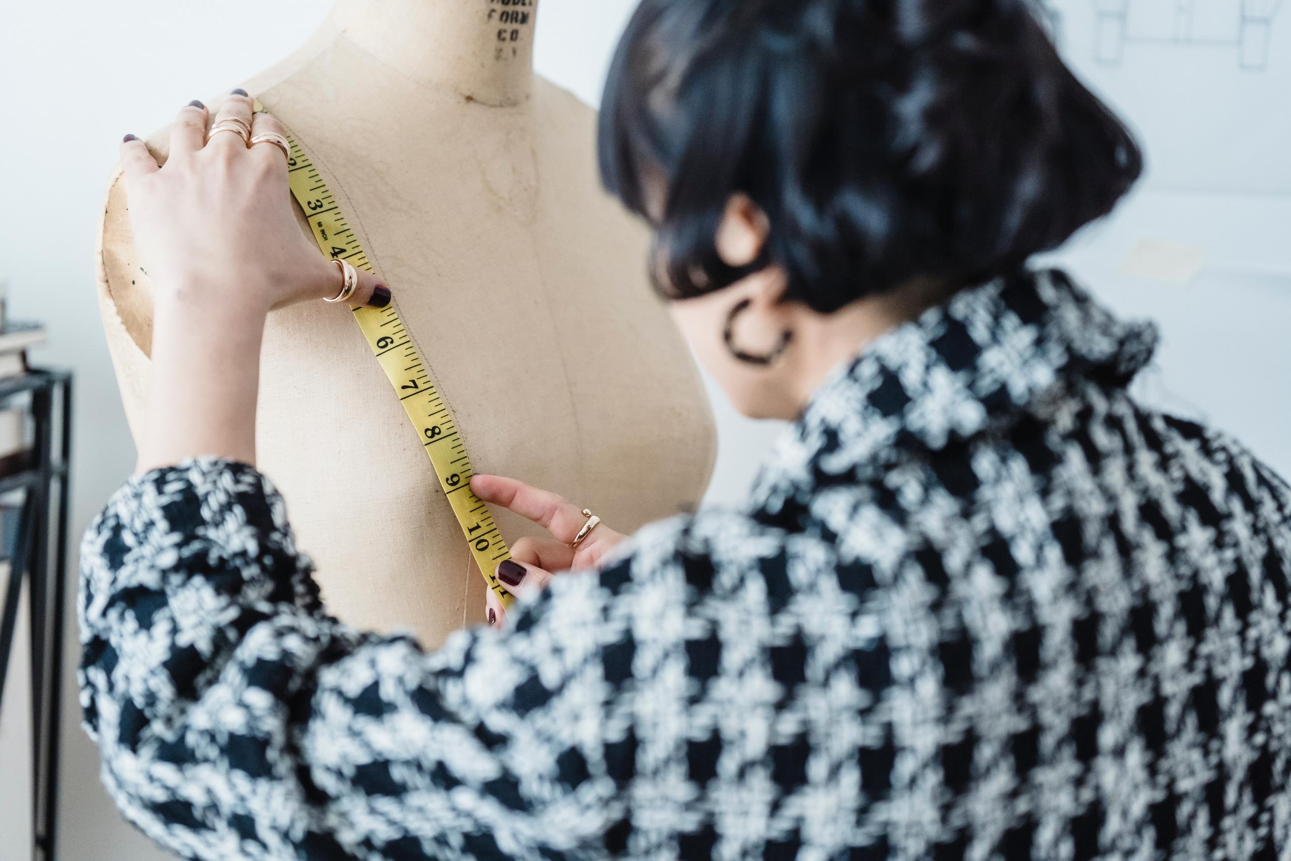 seamstress measuring dress form