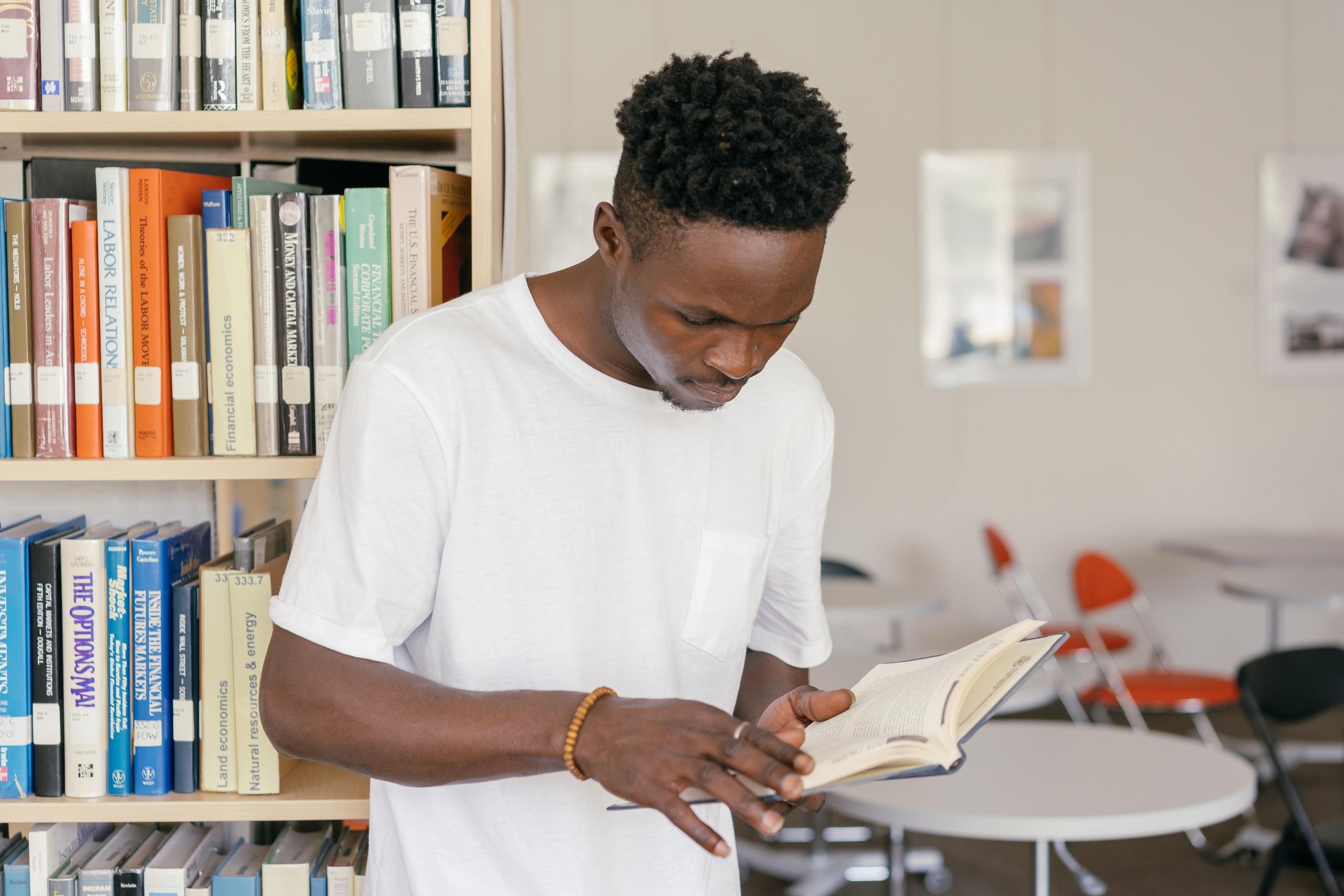 man reading book while standing