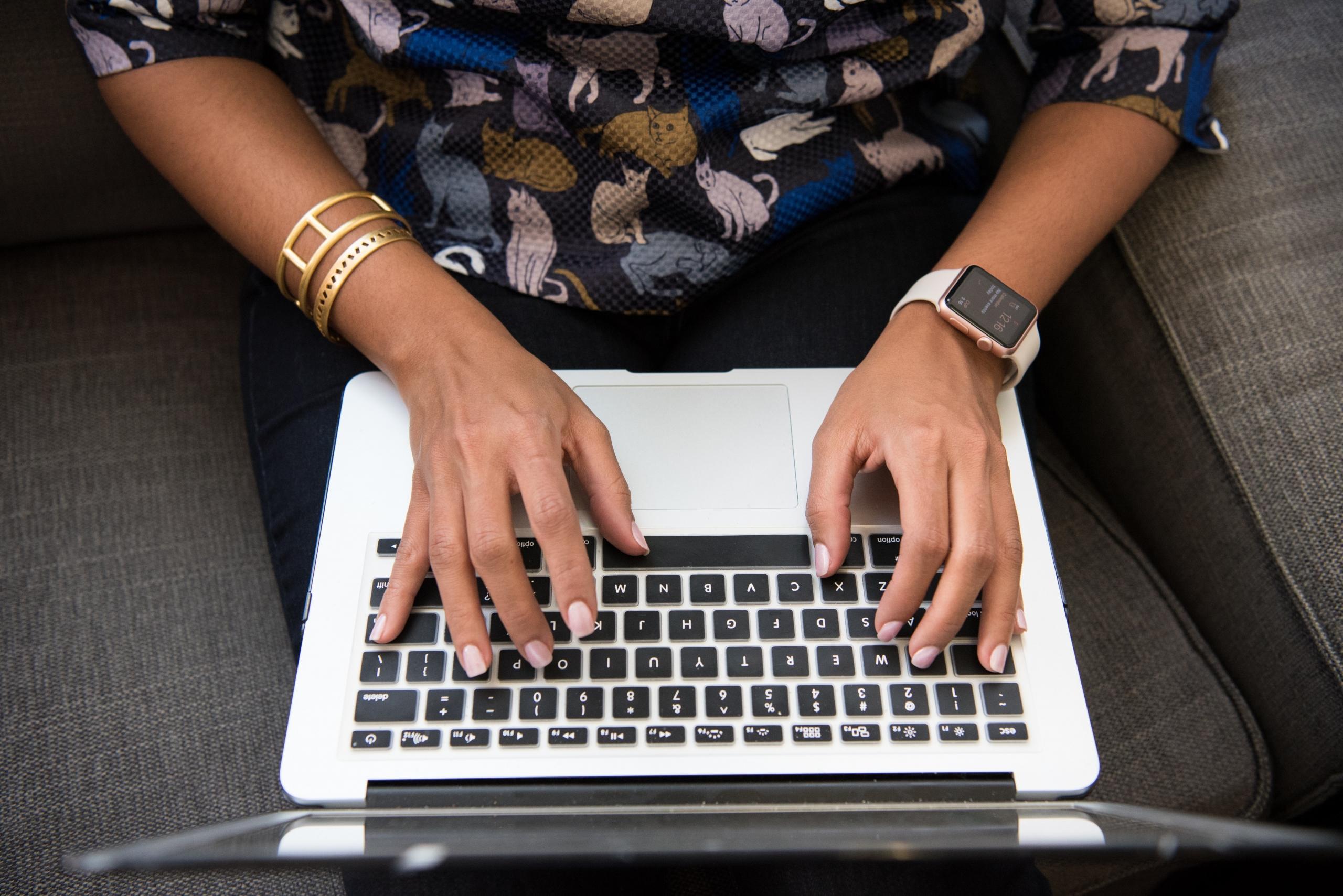 close up of woman's hands typing on laptop keyboard